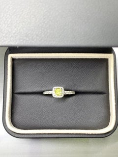 0.82ct cushion fancy intense yellow diamond engagement ring in platinum.
