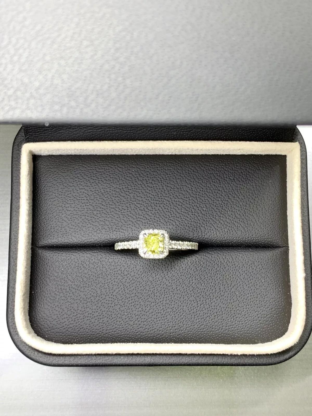 0.82ct cushion fancy intense yellow diamond engagement ring in platinum.