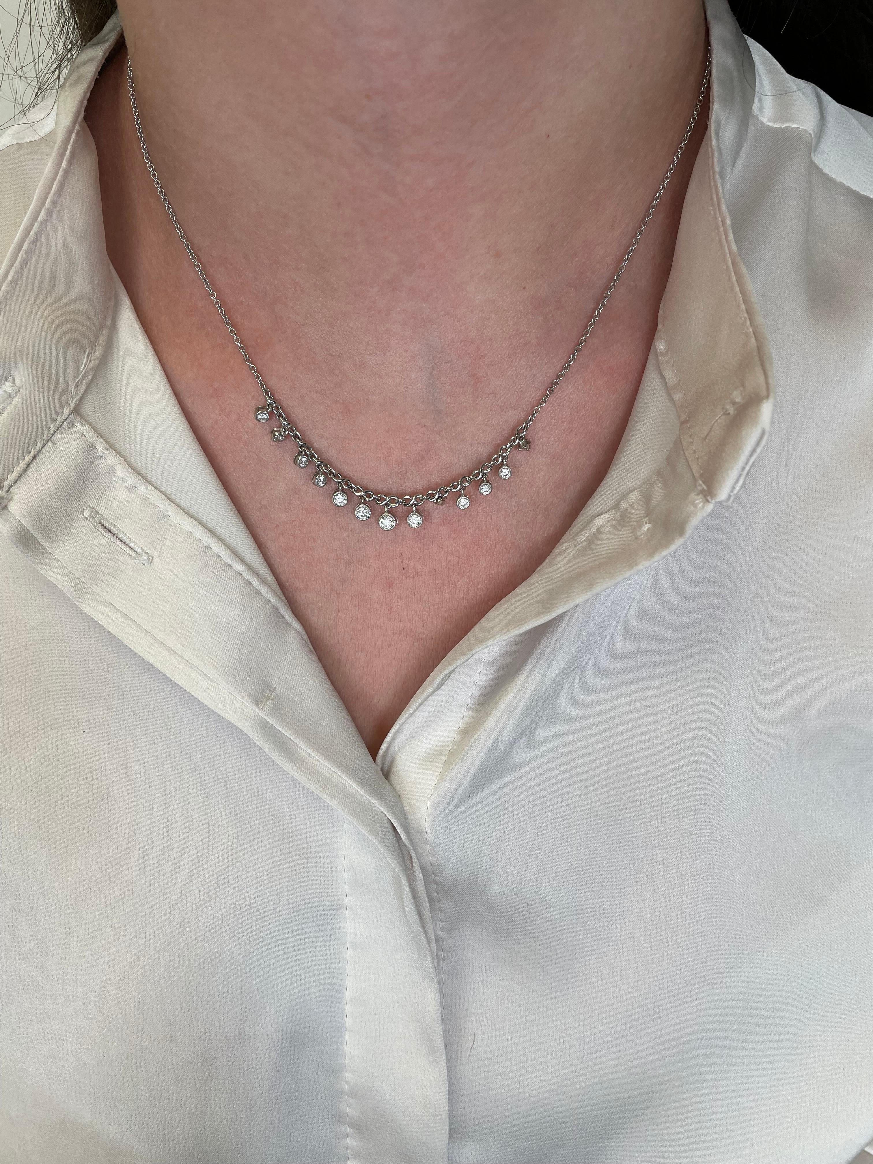 Lovely dangling diamond necklace, bezel set.
13 round brilliant diamonds, 0.82 carats. Approximately G/H color and SI clarity. 18-karat white gold.
Accommodated with an up to date appraisal by a GIA G.G. upon request. Please contact us with any