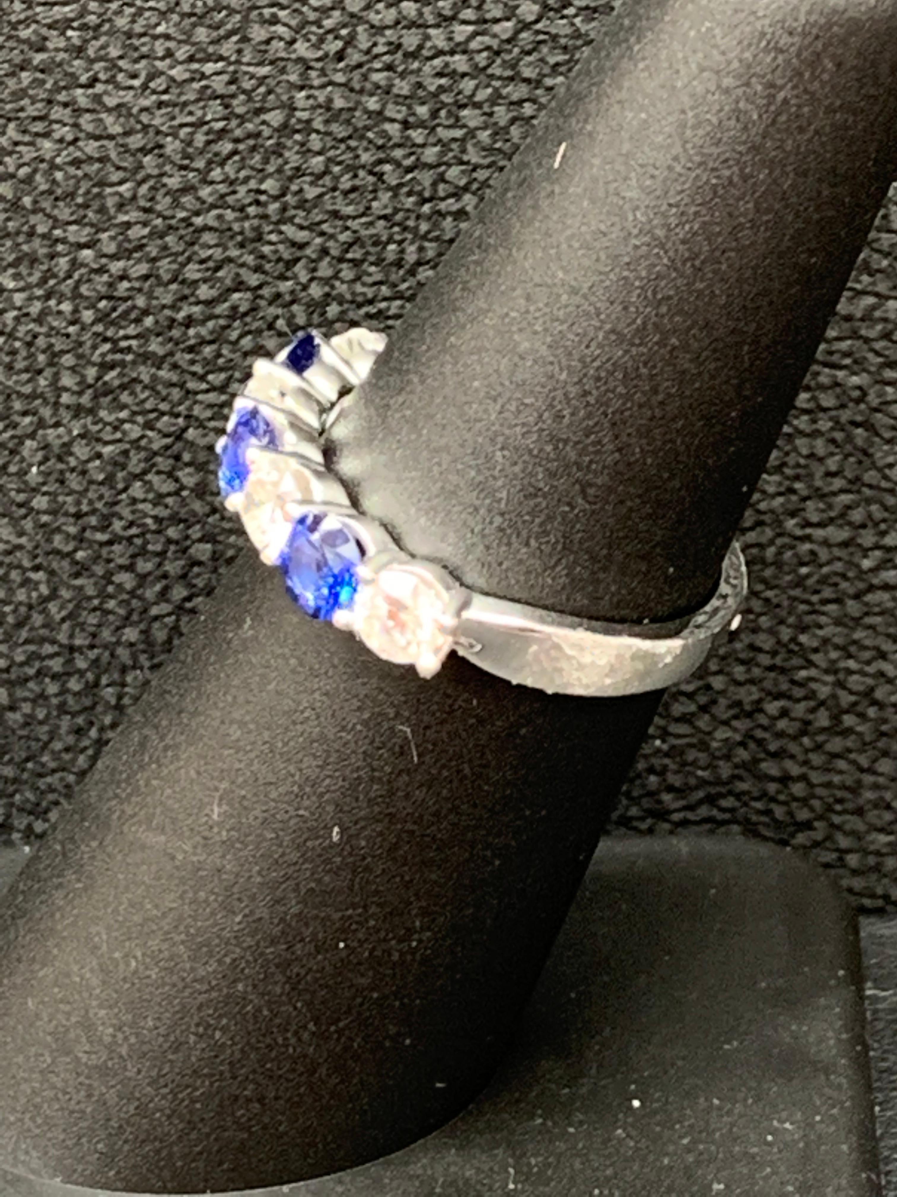 A fashionable and classic wedding band showcasing 3 color-rich blue sapphires weighing 0.83 carats total that alternate with 4 brilliant round diamonds weighing 0.75 carats total. Stones are secured with a shared prong setting made with 14 karats