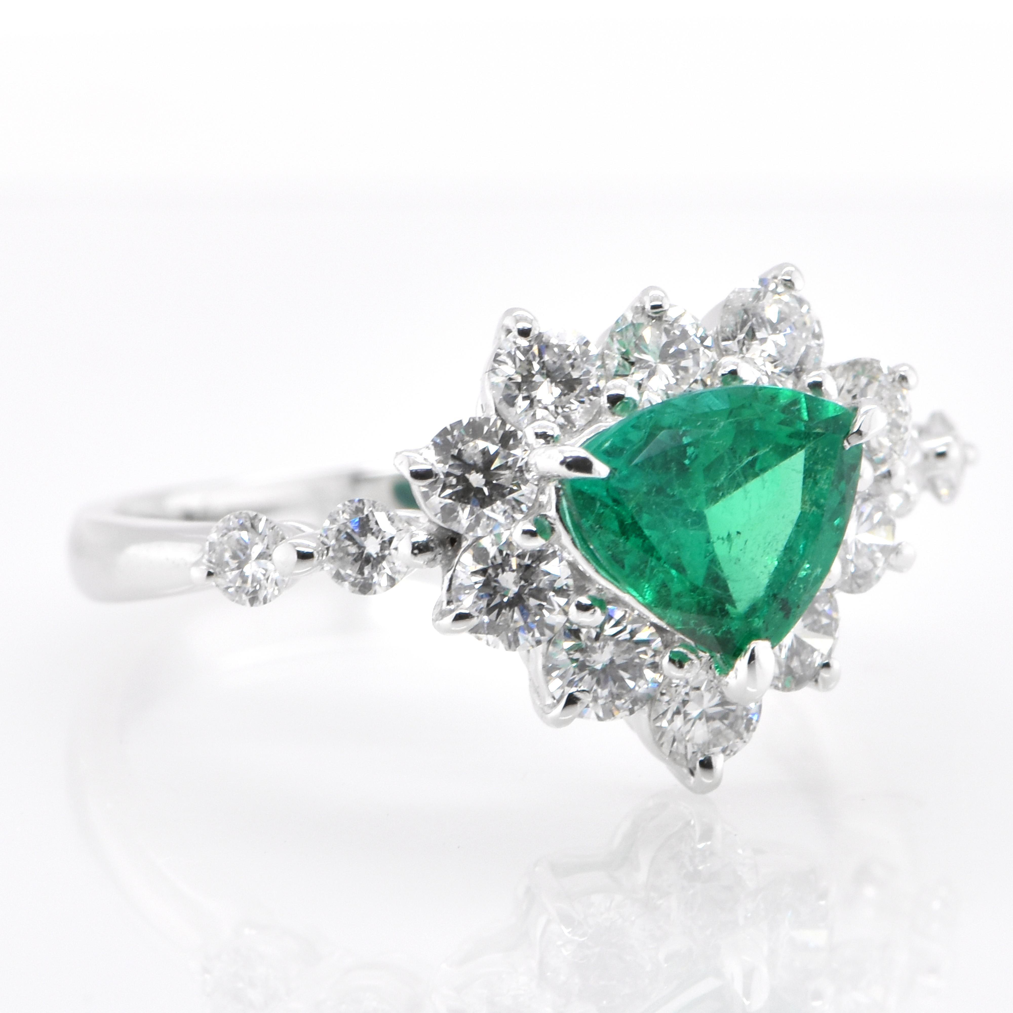 Modern 0.83 Carat Natural, Trillion Cut Emerald and Diamond Ring Set in Platinum