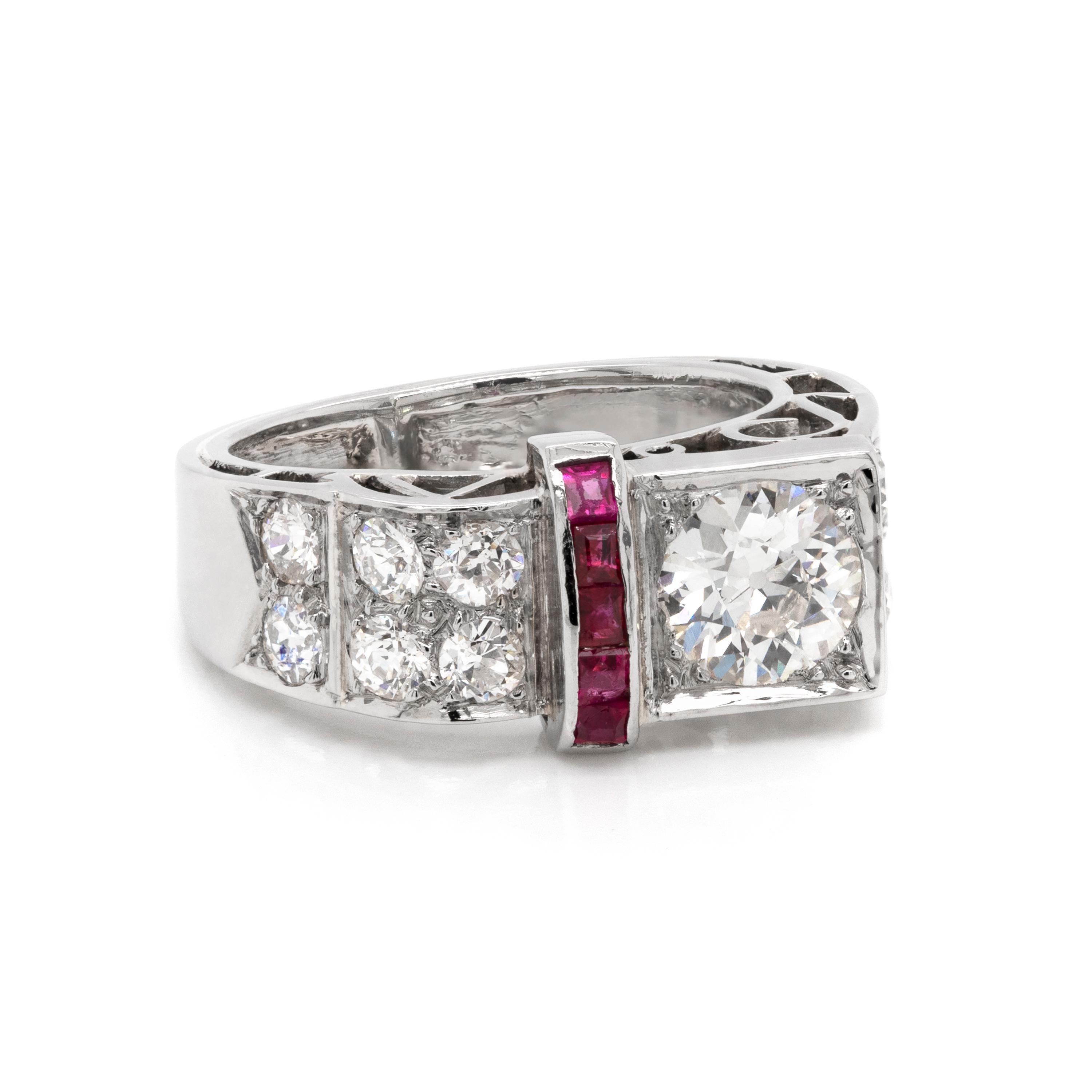 This one of a kind Art Deco style ring is unique in its shape, designed at an angle with scrolled open work details. It features an old European cut diamond weighing 0.83ct pavé set on its front edge, accompanied by a contrasting vertical line of 5