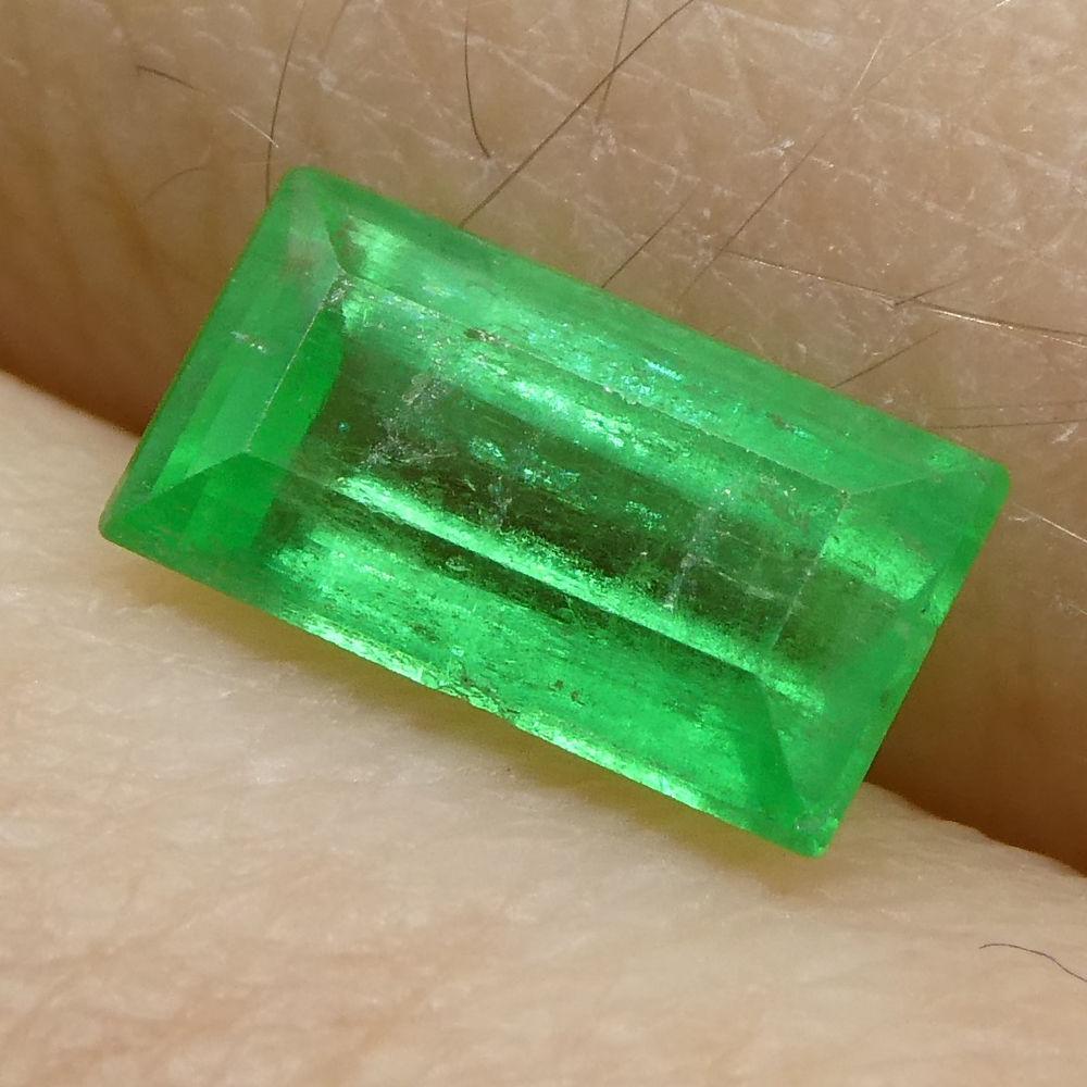 Description: 
Gem Type: Emerald   
Number of Stones: 1  
Weight: 0.83 cts  
Measurements: 7.52x4.17x3.23 mm  
Shape: Baguette  
Cutting Style Crown: Step Cut  
Cutting Style Pavilion: Step Cut   
Transparency: Transparent  
Clarity: Slightly