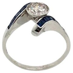 0.83ct Round Solitaire I/VS Diamond Set Crossover Ring with 12 Square Sapphires