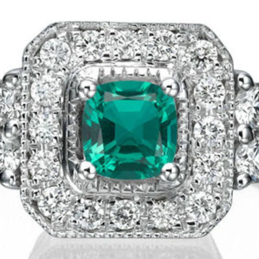 This beautiful Halo with accents vintage promise ring is made of 18k milgrain white gold with a cushion-cut central Emerald which is accompanied by 22 meticulously crafted melee diamonds . This high quality Halo pave style solitaire with accents