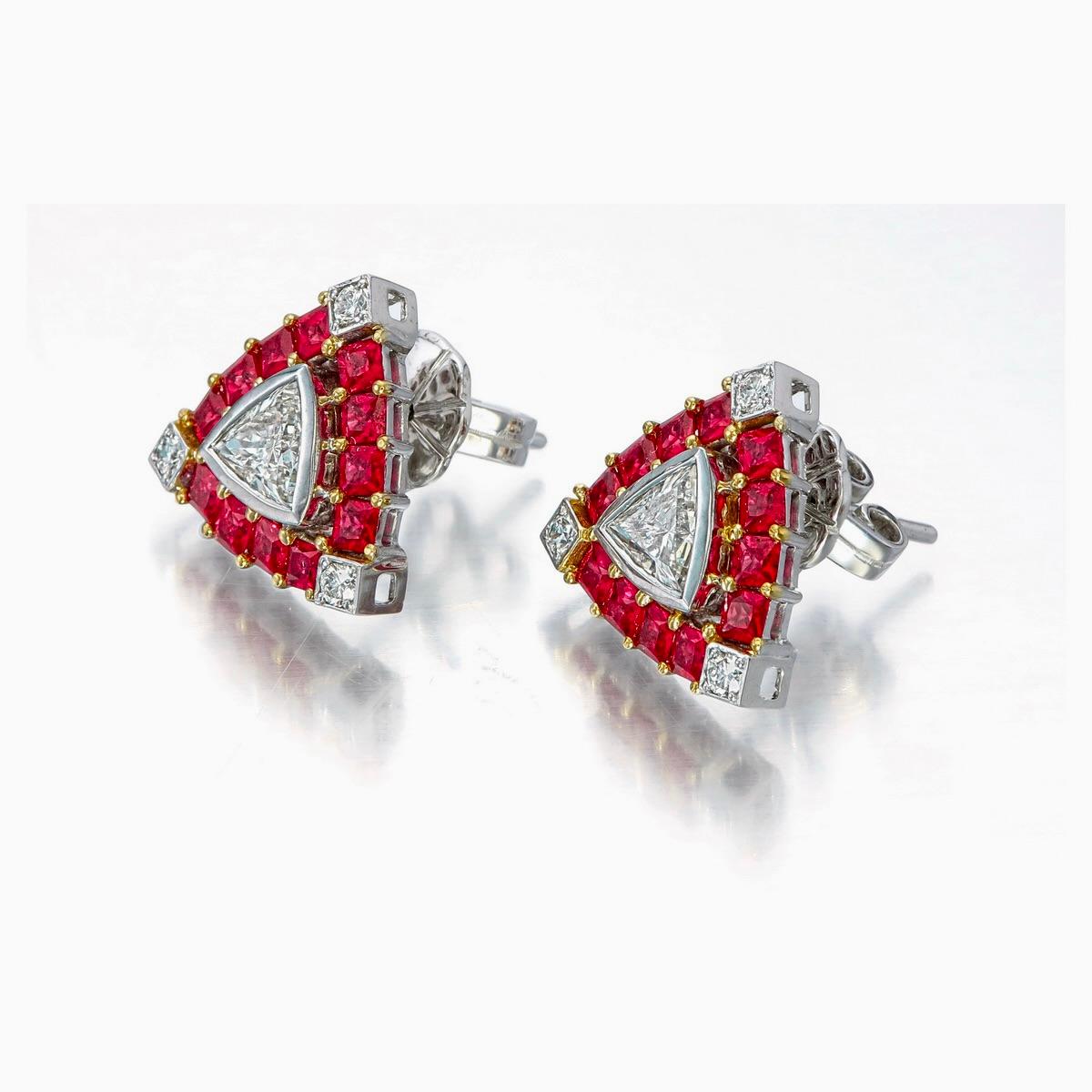 This brand new pair of diamond and ruby earrings from Rewa jewels, made in 18 karat white gold.

 The two centre piece diamonds are trillion shaped in fancy cut weighing approximately 0.84 carat total.The approximate colour of the diamonds is I-J