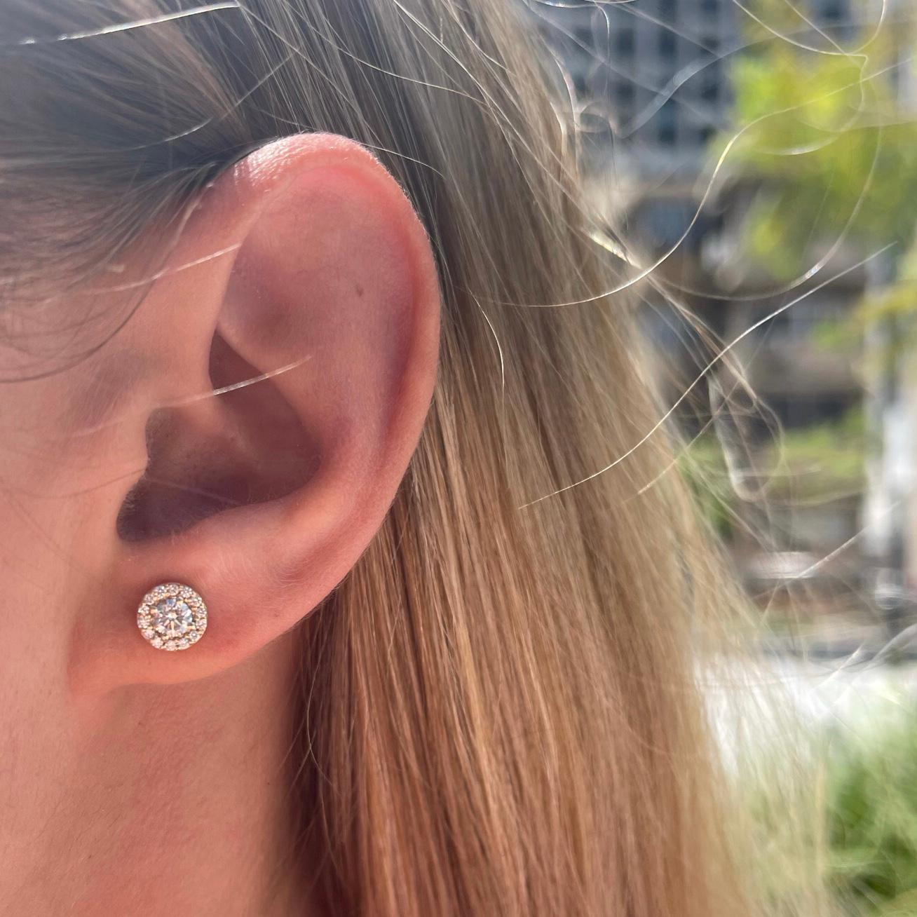 halo diamond earrings on ear