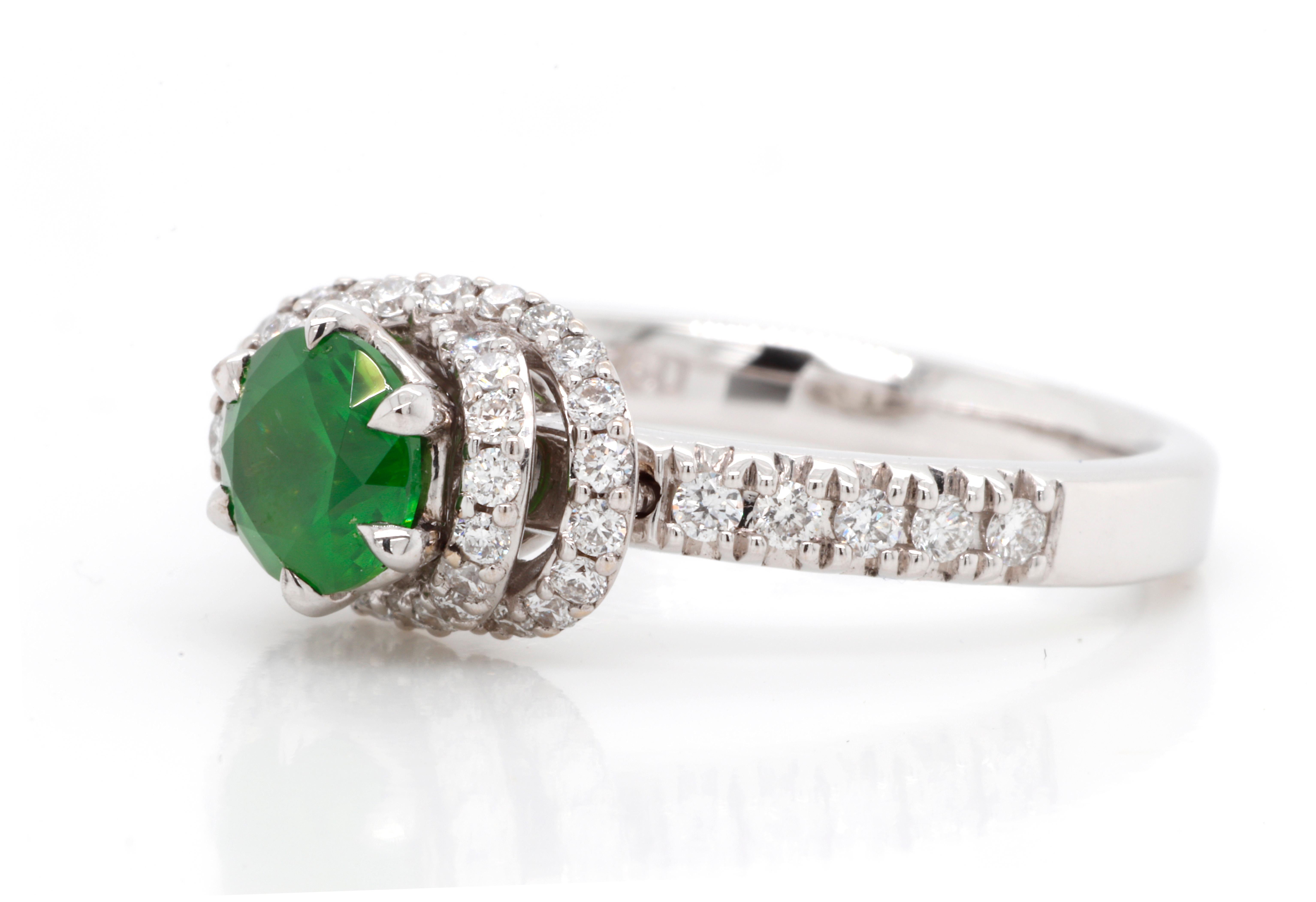 Exquisite 18K White Gold Demantoid Ring with Diamonds. Featuring 0.84 ct of top quality Russian Demantoid combined with natural 0.4 ctw Diamonds G-H color and VVS1 clarity. 
Demantoid, featured in this Ring, is a unique rare stone called a star of