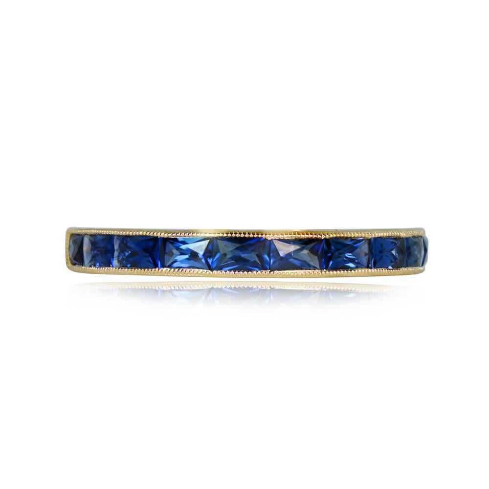 This exquisite half-eternity band, crafted in 18k yellow gold, features elongated French cut sapphires set in a channel setting. The total weight of the sapphires is 0.84 carats, creating a captivating and refined look. Adding to its charm, the