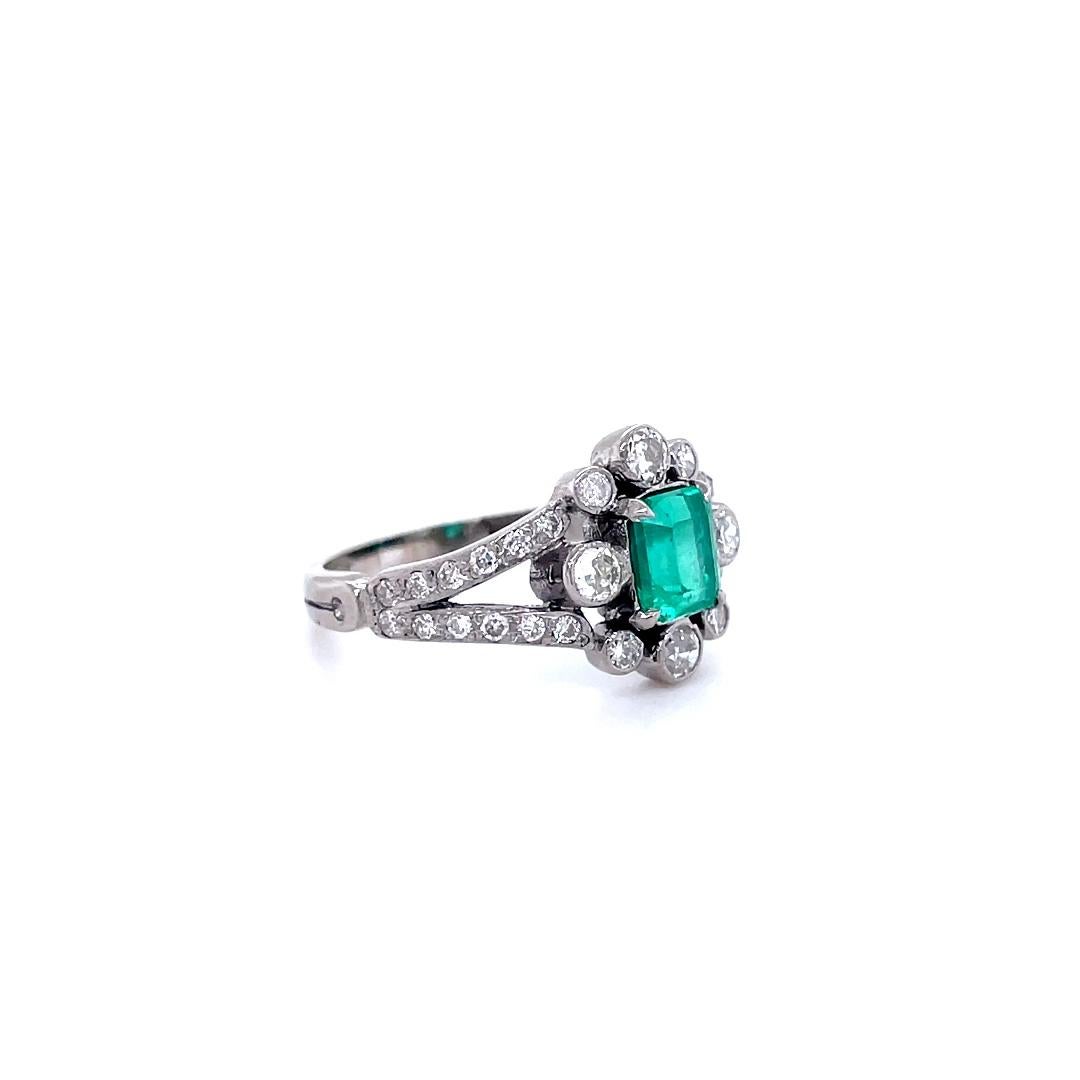An 0.85 carat Columbian emerald and diamond 18 karat white gold engagement ring, circa 1950

This vintage handcrafted ring is set to its centre with a 0.85 carat Columbian emerald cut emerald within a frame of bezel set old cut diamonds of