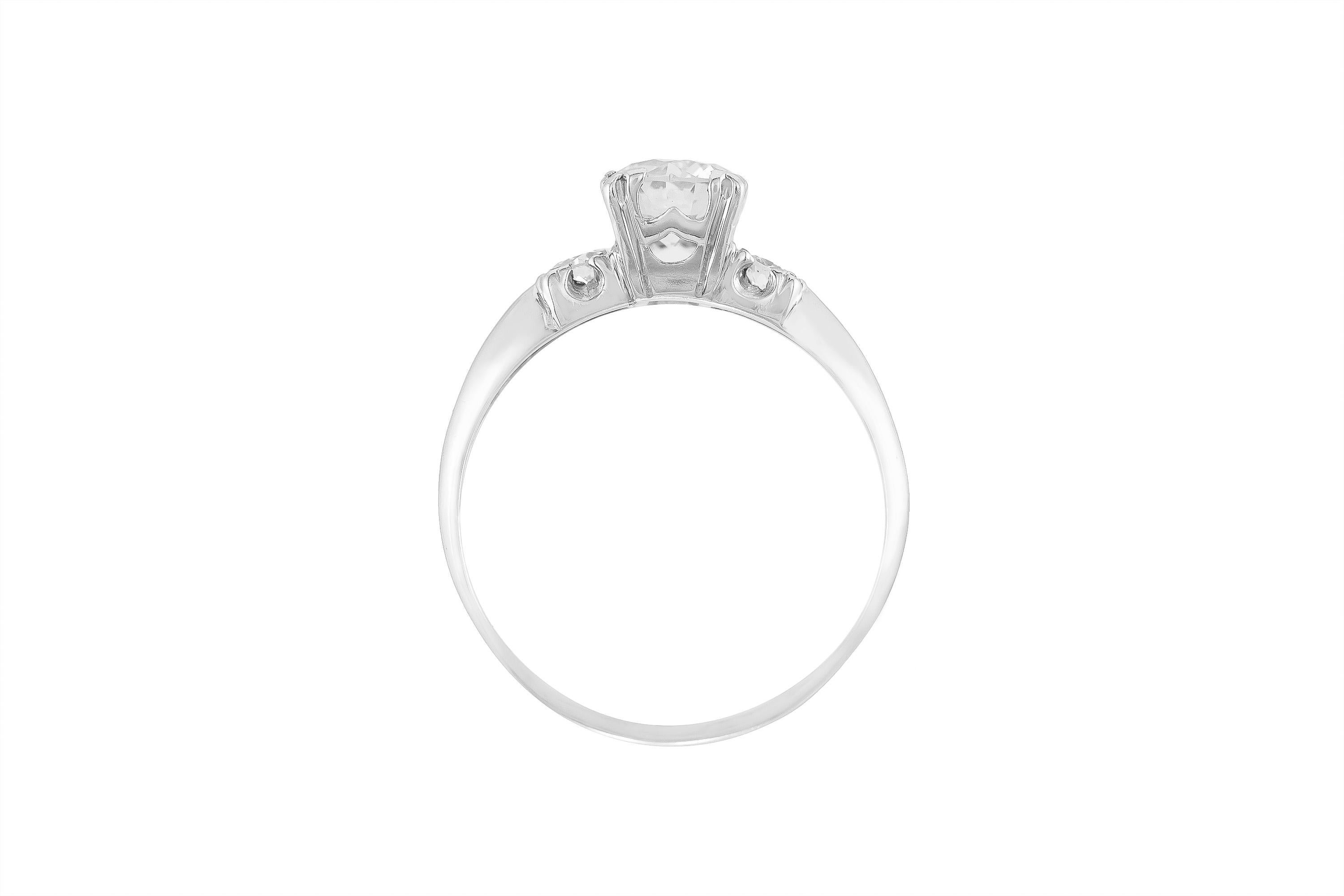 Finely crafted in platinum with a center stone weighing approximately 0.85 carat and two side diamonds weighing approximately 0.20 carat total. Color I Clarity SI1. 
