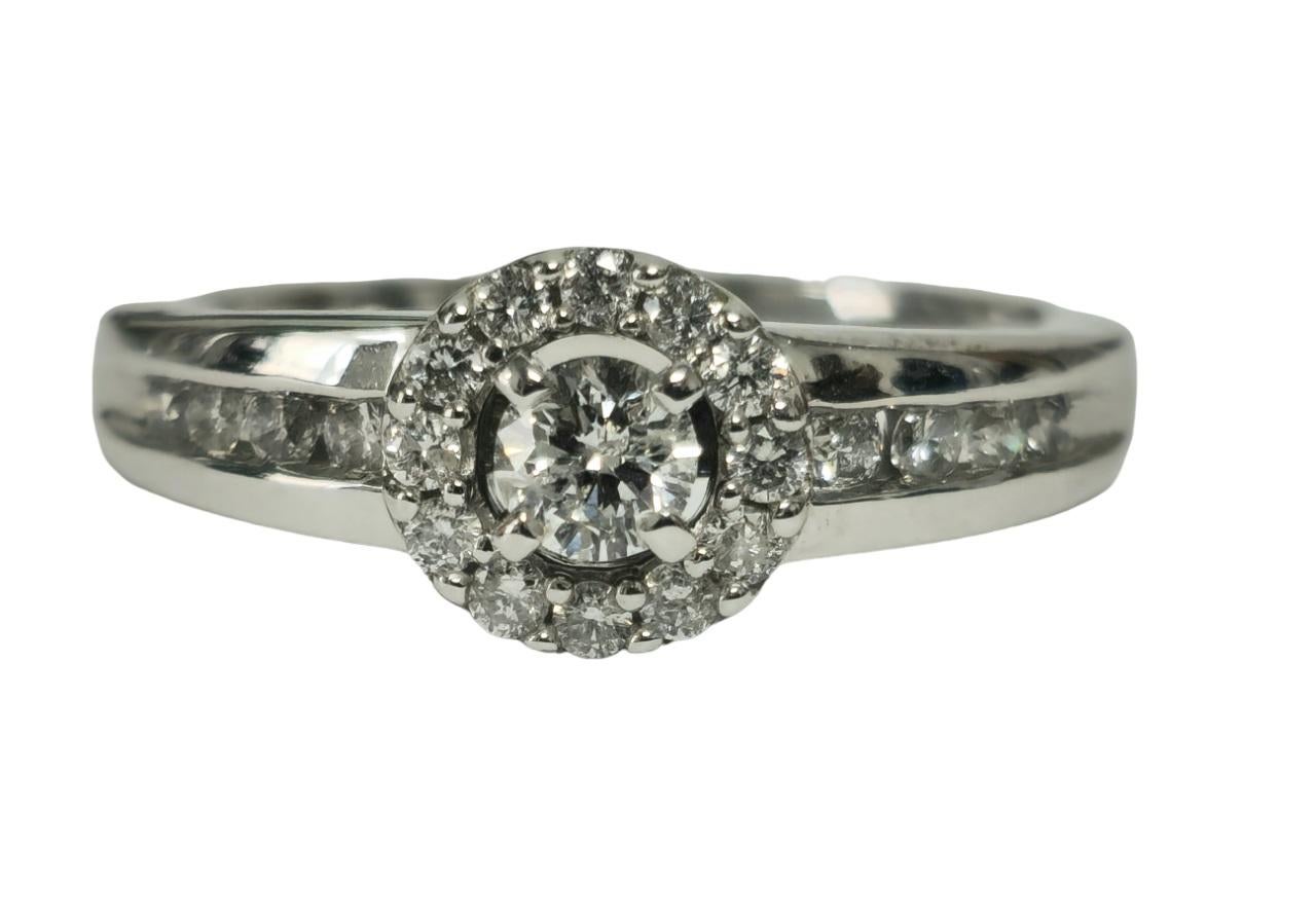 Indulge in elegance with our Ladies Diamond Engagement Ring, crafted from lustrous 14K white gold. Adorned with a total carat weight of 0.85 carats of round brilliant cut diamonds, each boasting F color and VS-SI clarity, this ring exudes timeless