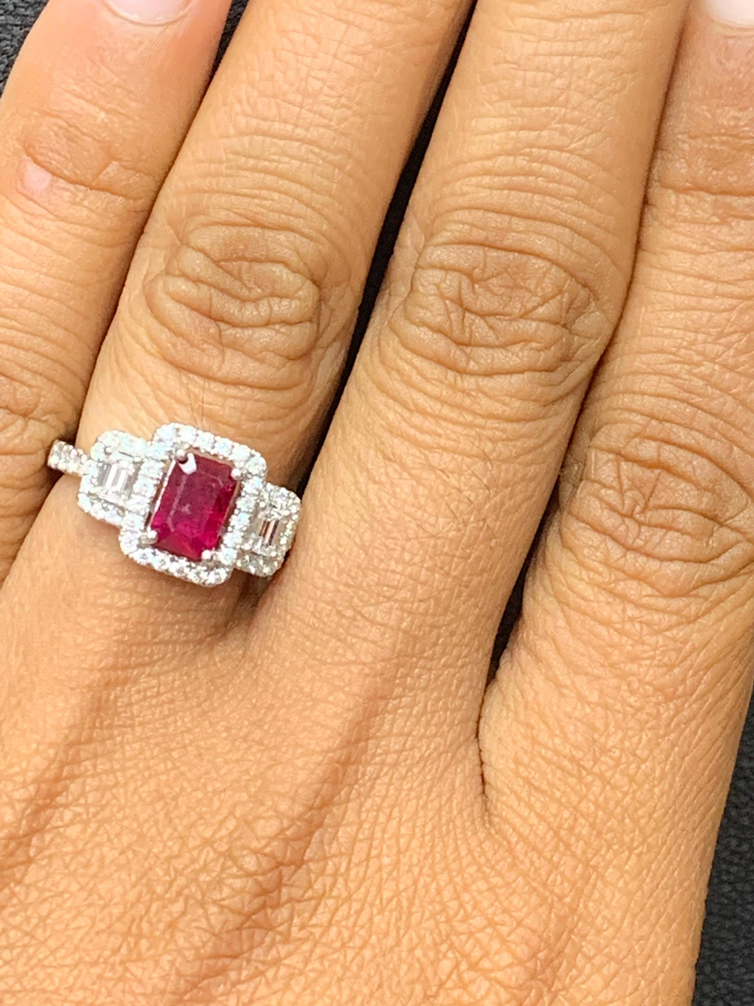 Gorgeous 18k white gold engagement ring set with a 0.85 carat emerald cut ruby center stone surrounded by a row of diamonds weighing 0.44 carat total and flanked by an 0.28 carat Diamonds on each side. The ring is made in 18K White Gold.

Size 6.5