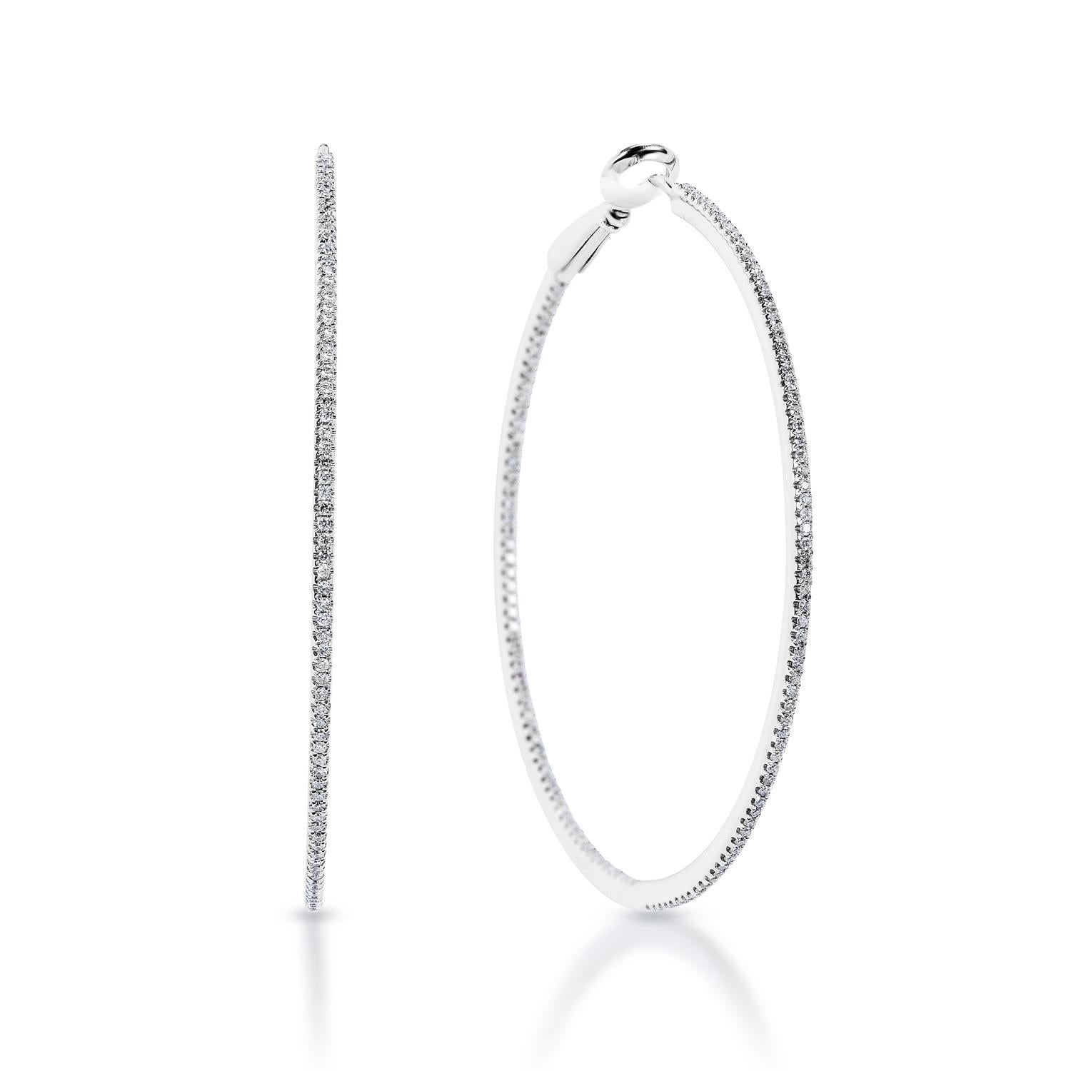 Diamond Large Hoop Earrings:

Diameter: 2 inches 
Carat Weight: 0.85 Carats
Shape: Round Brilliant Cut
Metal: 14 Karat White Gold
Style: Large Hoop Earrings