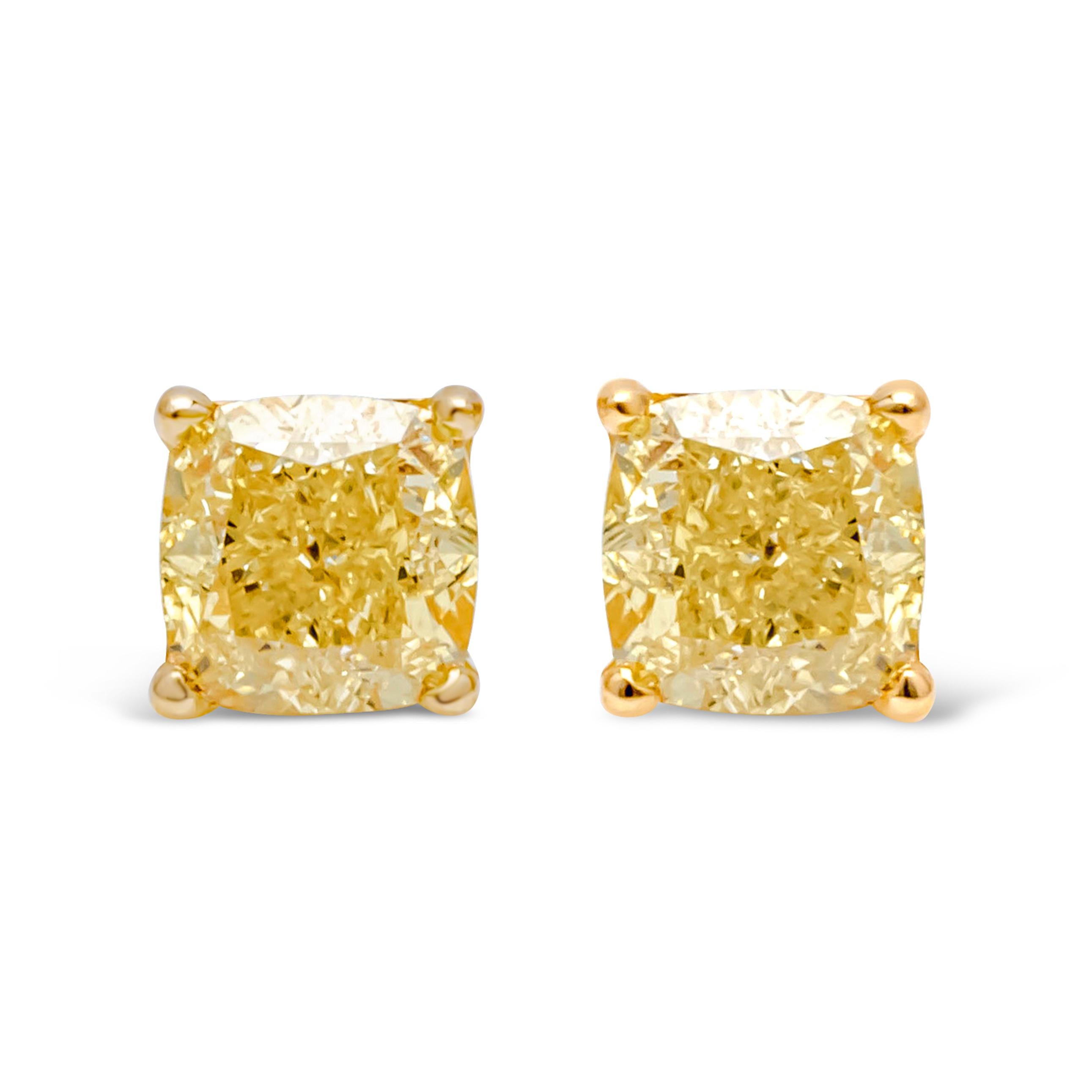 A simple and vibrant pair of stud earrings showcasing a color-rich cushion cut fancy Intense yellow diamonds weighing 0.85 carats total, VS+ in Clarity. Set in a timeless four prong push back setting and Finely made in 18k yellow gold.

Roman