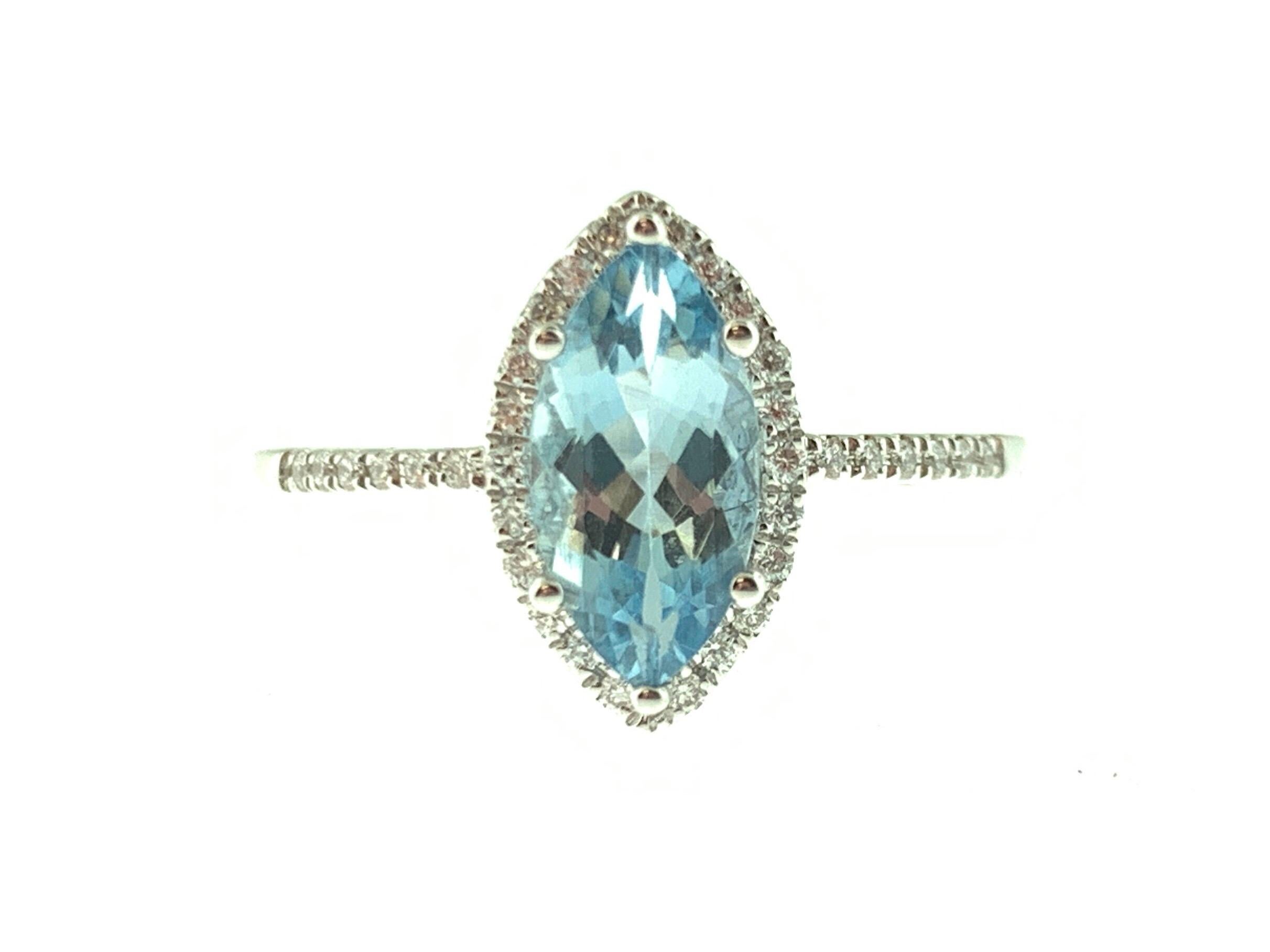 This stunning cocktail ring showcases a beautiful 0.85 Carat Marquise Aquamarine with a Diamond Halo. The Aquamarine sits on a Diamond Shank and is set in 14k White Gold. Total Diamond Weight = 0.13 Carats. Ring Size is 6 1/2.