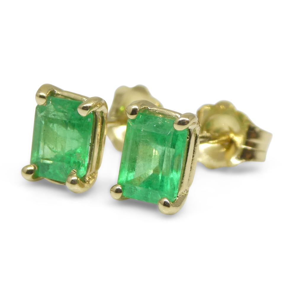 Contemporary 0.85ct Emerald Cut Green Colombian Emerald Stud Earrings set in 14k Yellow Gold For Sale