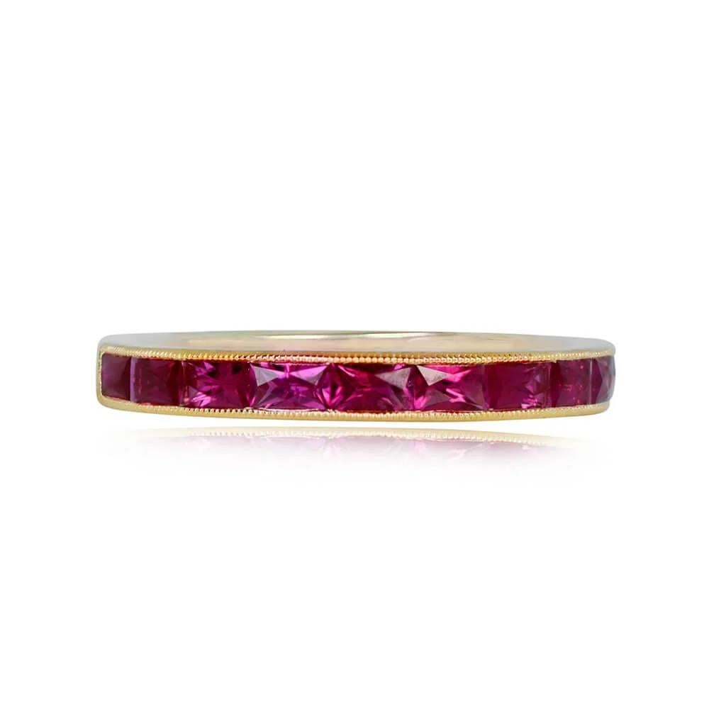 A captivating half-eternity wedding band in 18k yellow gold, featuring elongated French-cut natural rubies with a total weight of 0.85 carats. The rubies are meticulously set in a channel setting, accentuated by delicate fine milgrain detailing. The