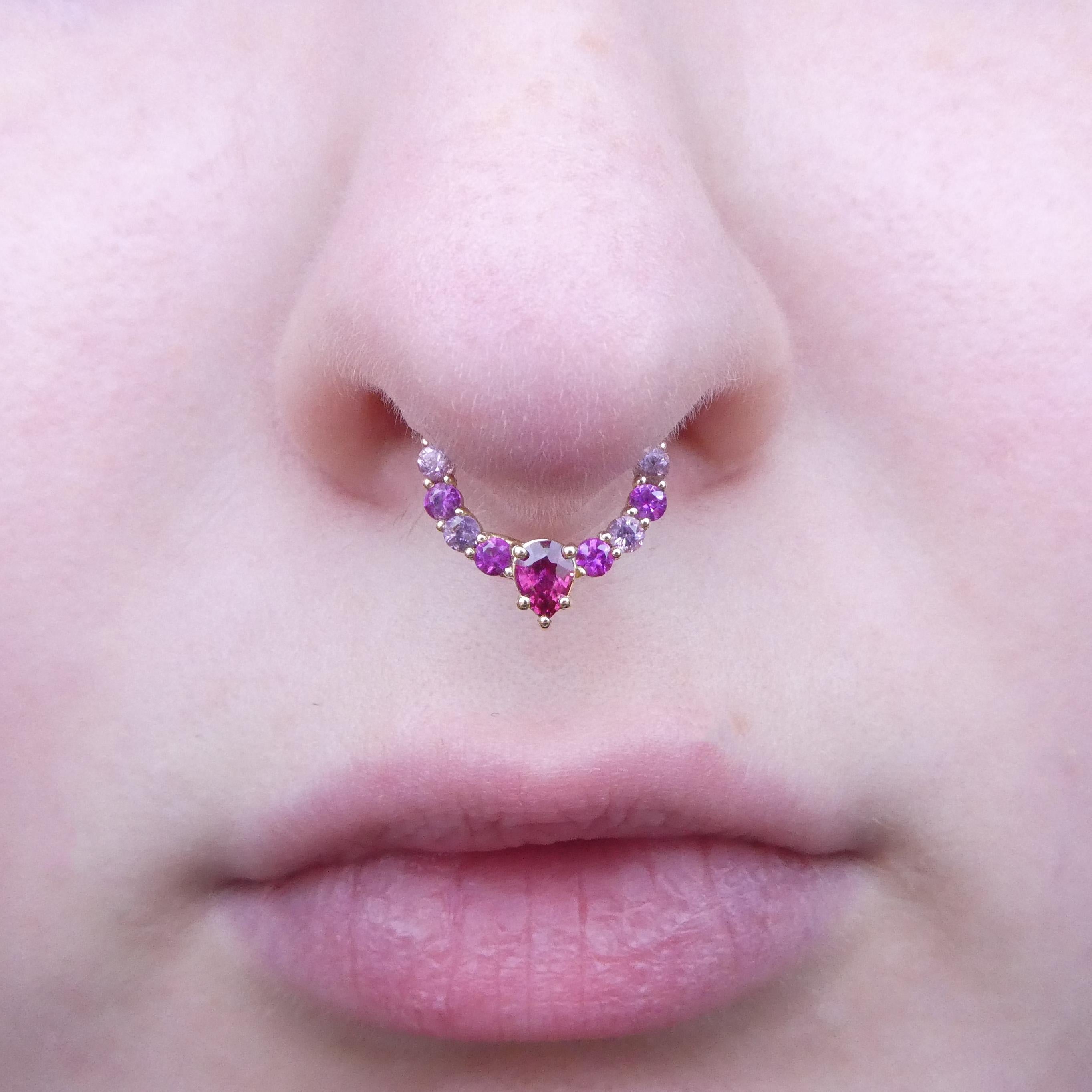 Diameter: 10mm
Thickness: 1.20 mm (16 Gauge)

 

Introducing our exquisite 0.85ct Round Ruby and Pink Sapphire Hinged Septum Clicker Hoop, a true masterpiece crafted to adorn and elevate your style. This stunning piece is meticulously designed and