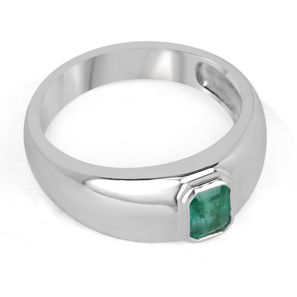 A stunning natural emerald solitaire ring. This beauty features a gorgeous emerald cut emerald that is under a carat yet displays a ravishing medium-dark green color with remarkable qualities. Set vertically in a sterling silver bezel