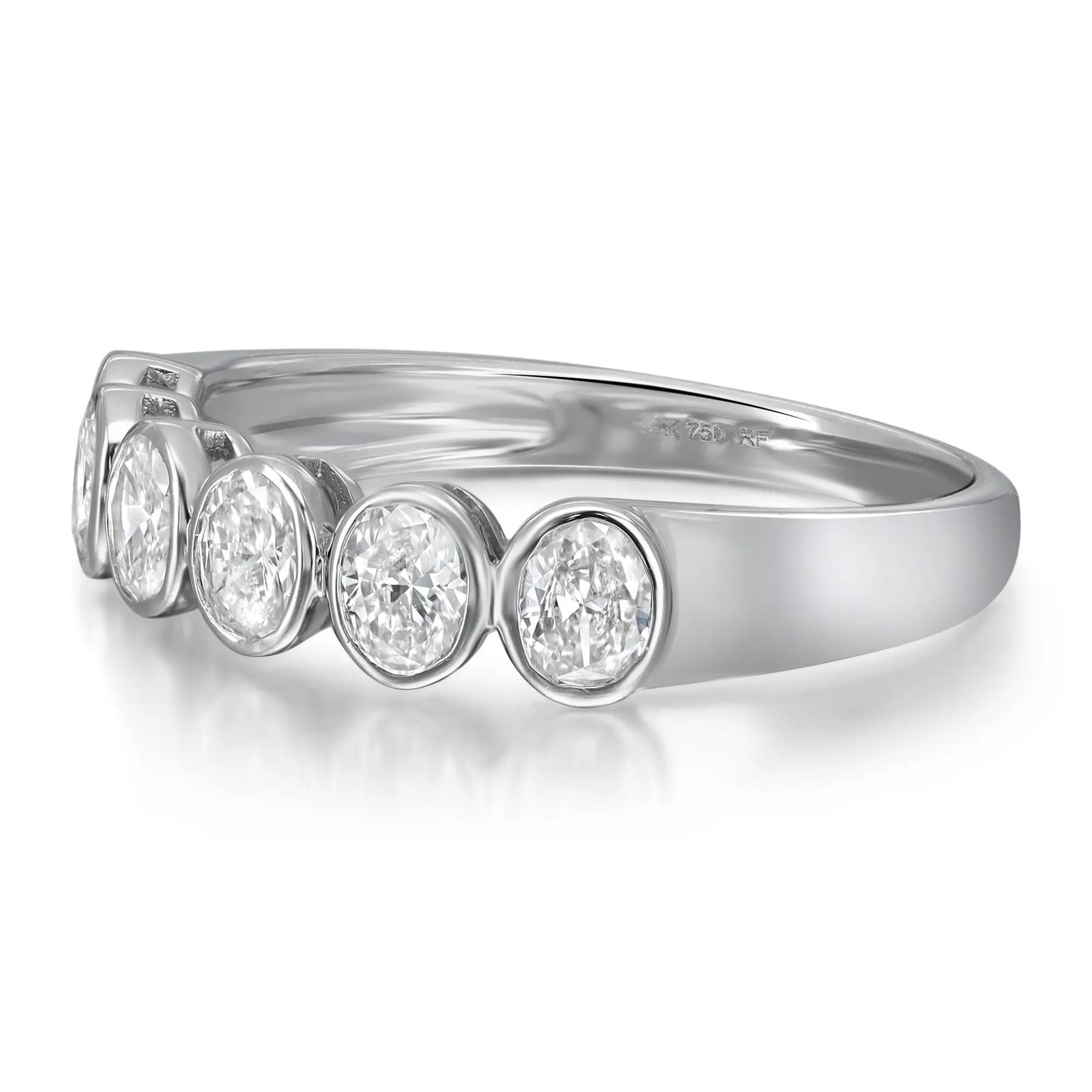 Celebrate everlasting love with this enchanting eternity band ring. Crafted in high polished 18K white gold. Showcasing 6 bezel set oval cut dazzling diamonds weighing 0.85 carat. Diamond quality: color G-H and clarity VS-SI. Ring size: 6.5. Width: