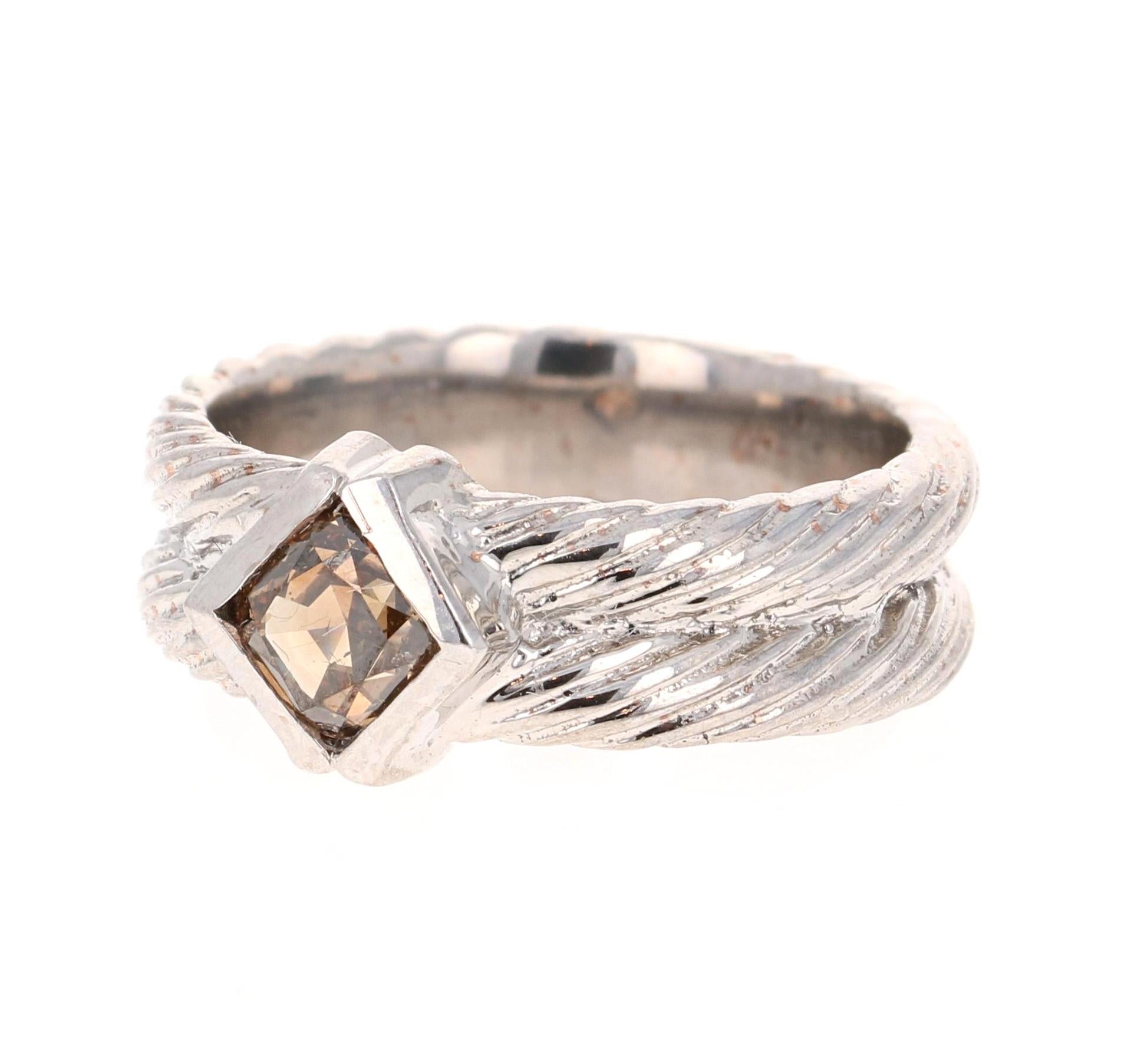This one of a kind ring has a 0.86 carat Cushion Cut Natural Brown/Champagne Colored Diamond with a clarity of SI1. The diamond measures at 6 mm x 4 mm and the thickness of the band is 6 mm. 

The band is set in 14 Karat White Gold and weighs