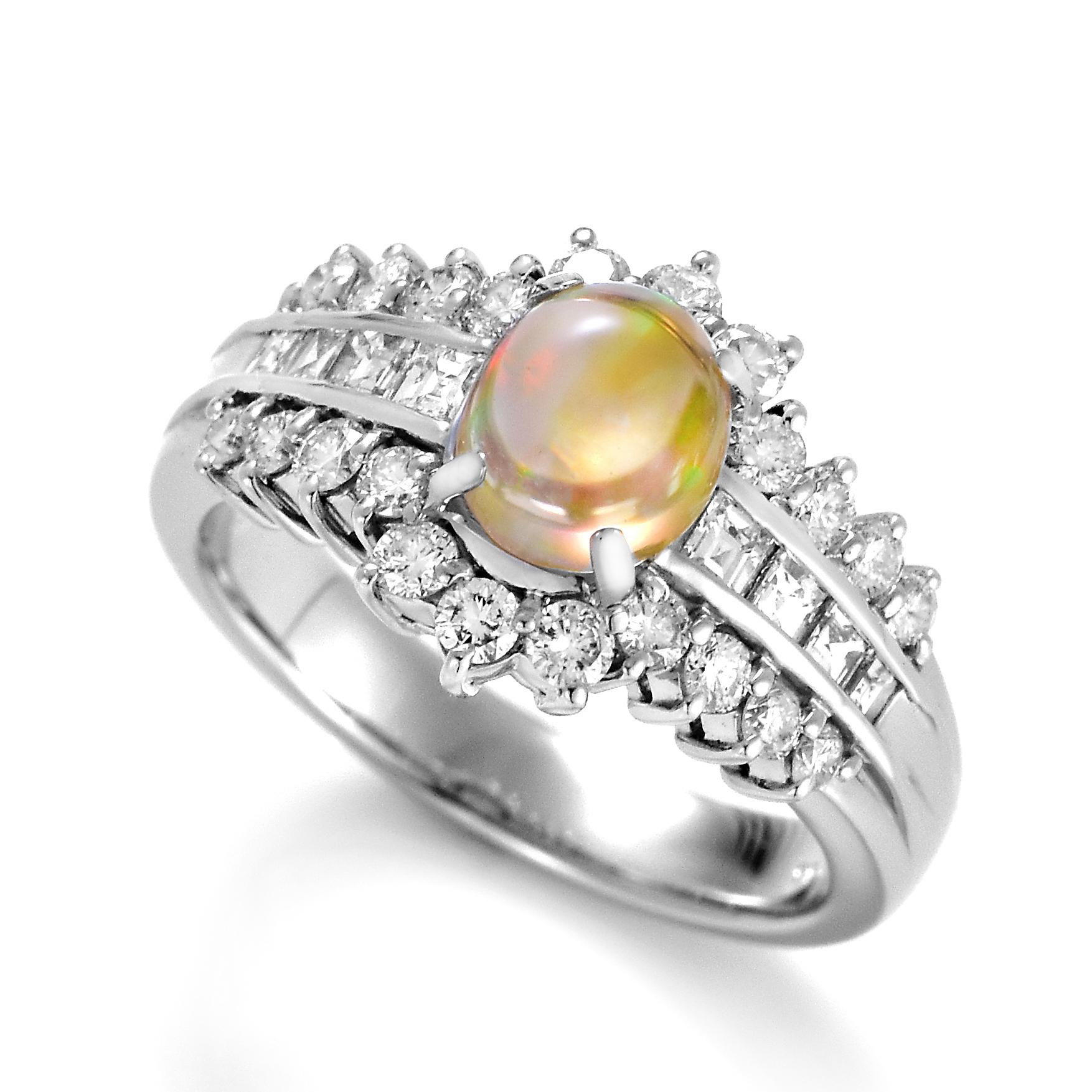 A beautiful ring featuring a 0.86 Carat Natural Mexican Fire Opal and 0.81 Carats of Diamond Accents set in Platinum. Opals are known for exhibiting flashes of rainbow colors known as 