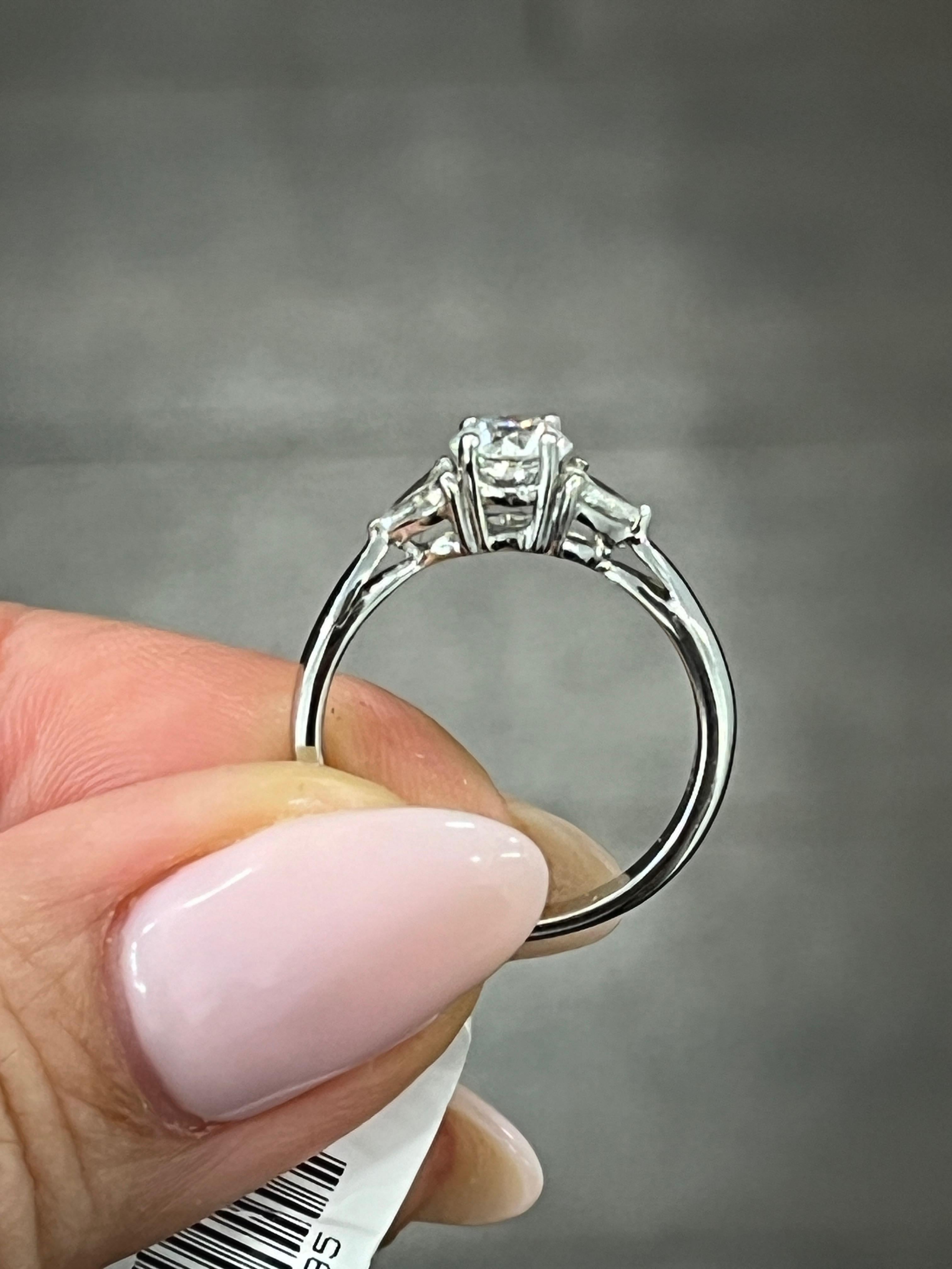 This beautiful 18k white gold ring features a stunning round diamond with a total carat weight of 0.86. The diamond is of F/G color grade and VS1/VS2 clarity grade, ensuring the highest quality sparkle. The ring is size 5.25 and has sizable options