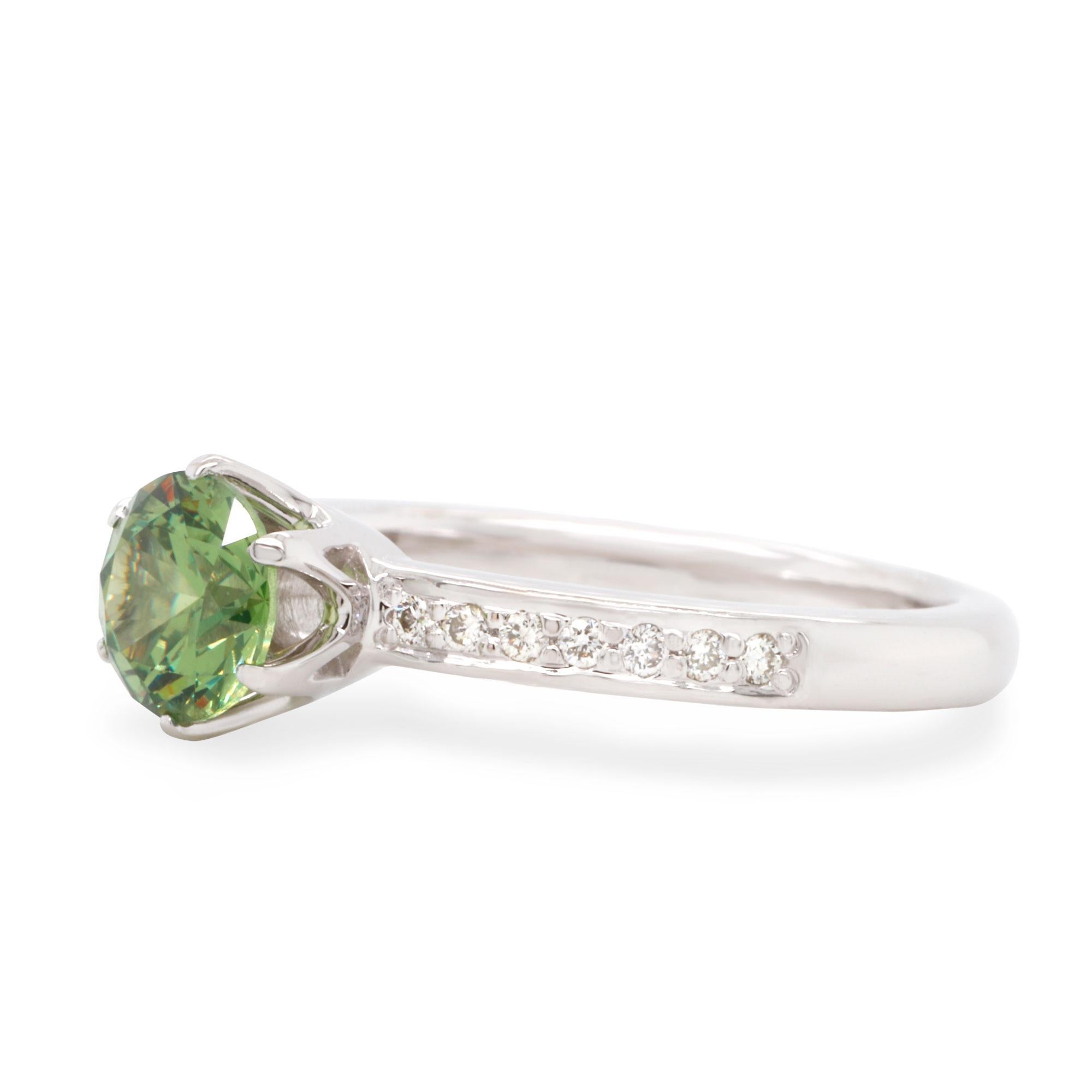 Stylish 14 Karat White Gold Demantoid Ring with Diamonds. Featuring 0.86 ct of top quality Russian Demantoid combined with natural colorless diamonds 0.1 ct total weight. Perfect as for special occasion as for everyday wear, it can be used as