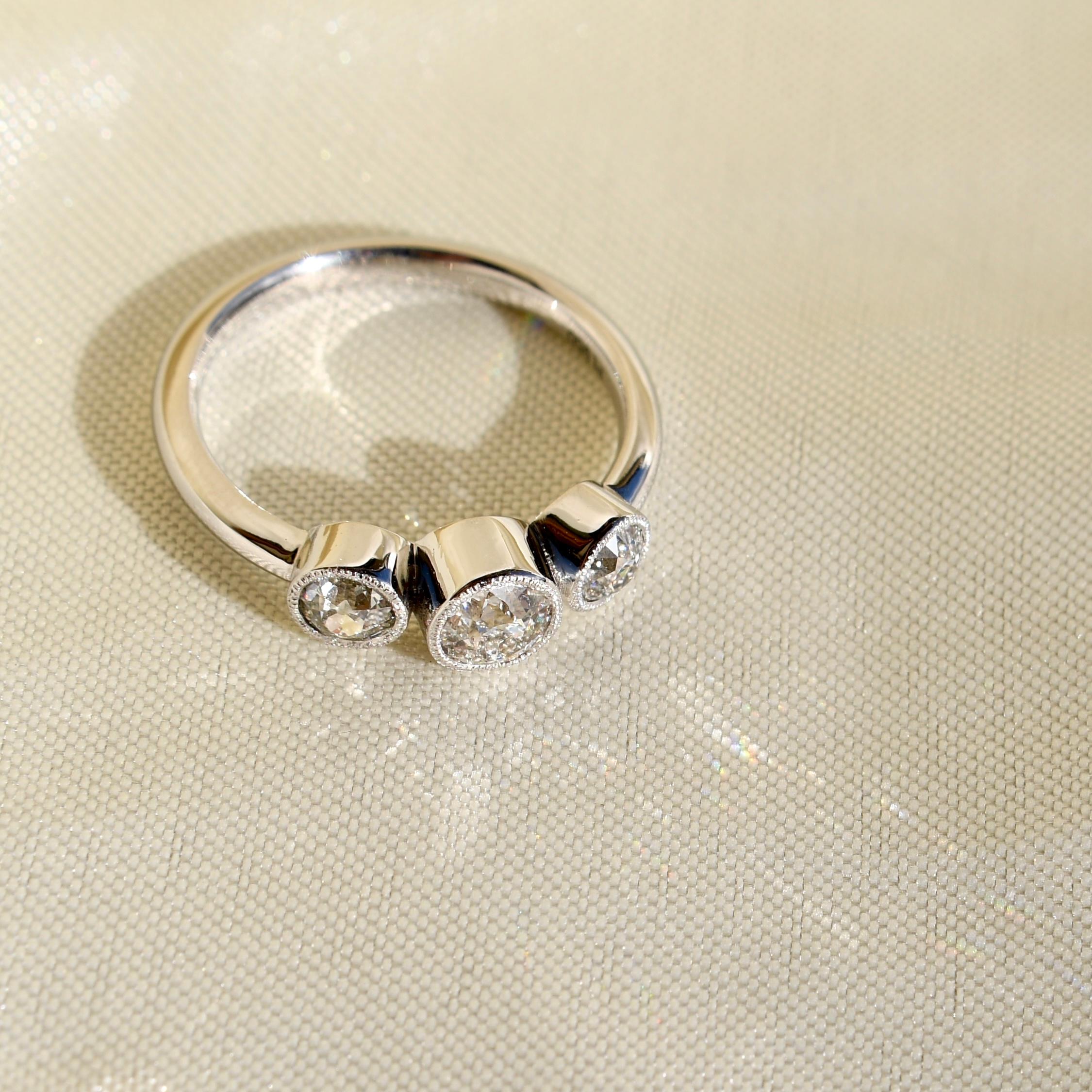 Old European Cut 0.86ct old European cut diamond three stone ring with Millegrain, IGI certified For Sale