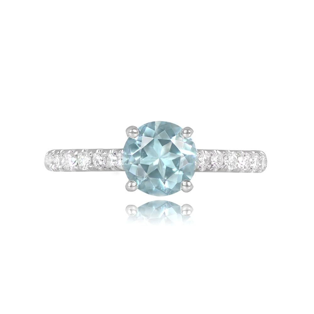 A ring with a 0.86-carat round-cut aquamarine in a prong setting, flanked by round brilliant cut diamonds on the shoulders with a total diamond weight of around 0.27 carats. The ring is beautifully crafted in 18k white gold.


Ring Size: 6.5 US,