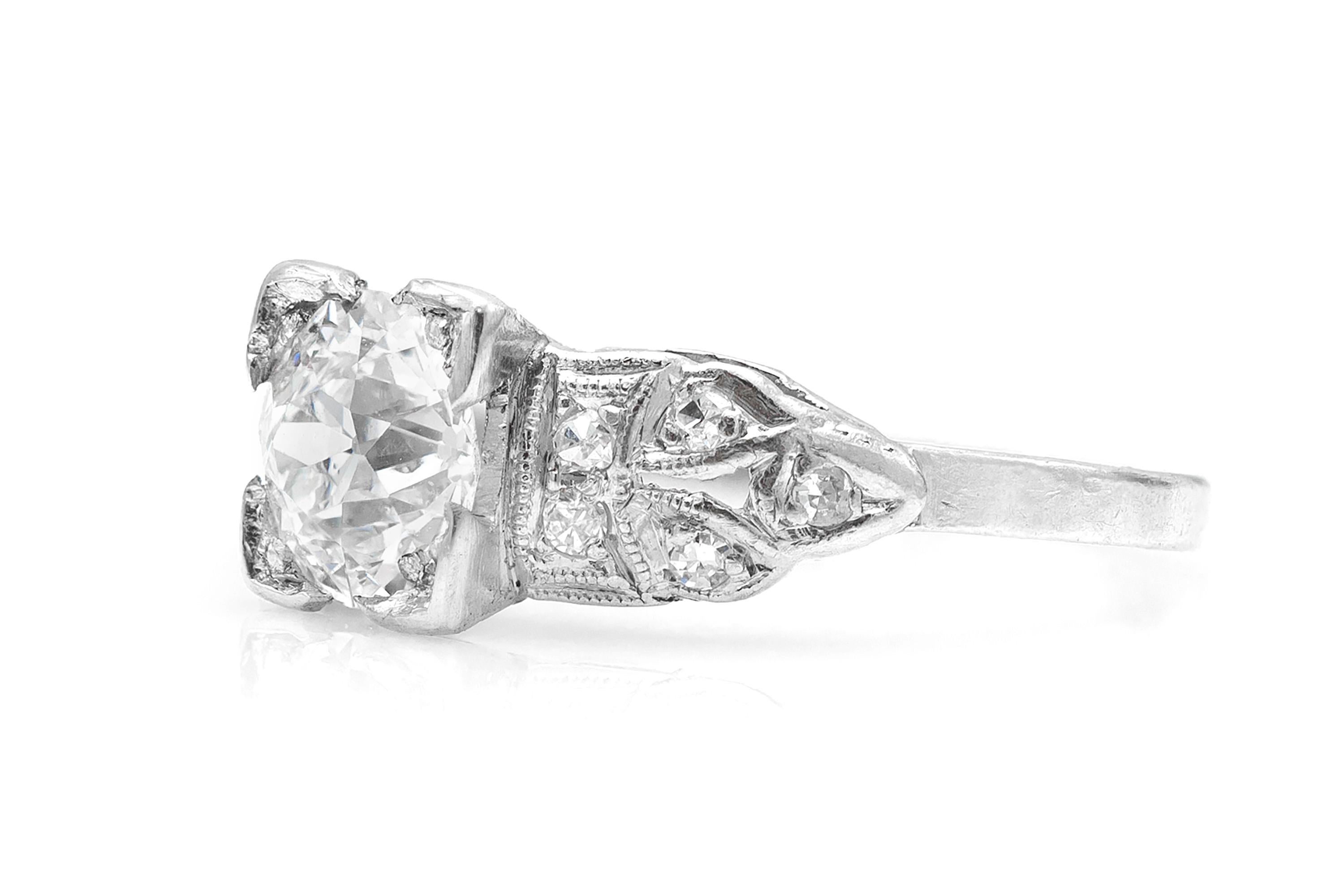 Finely crafted in platinum featuring a center diamond weighing 0.87 carat and surrounding round cut diamonds in an Art Deco setting.
Size 3 3/4 (resizable).