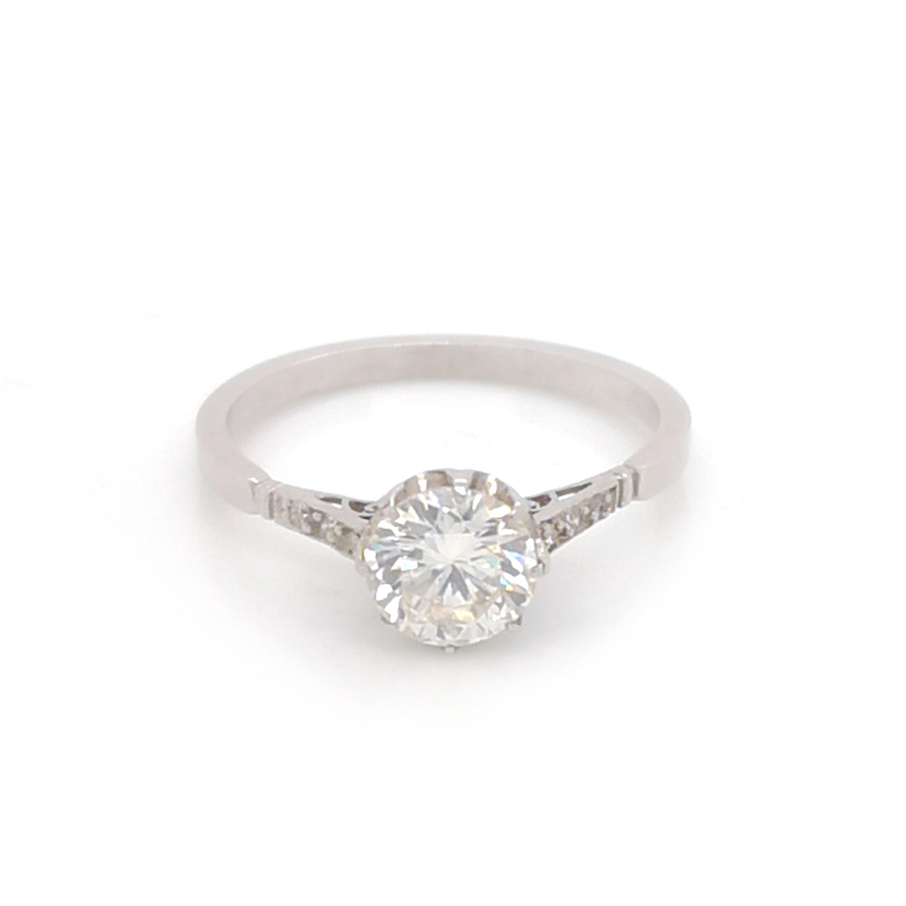 A diamond solitaire ring, set with a 0.87ct Edwardian-cut diamond, with three old-cut diamonds set in each shoulder, mounted in platinum. In our opinion, the colour is I-J, the clarity is VS2.

Finger size N 1/2 UK / 6 3/4 US.
