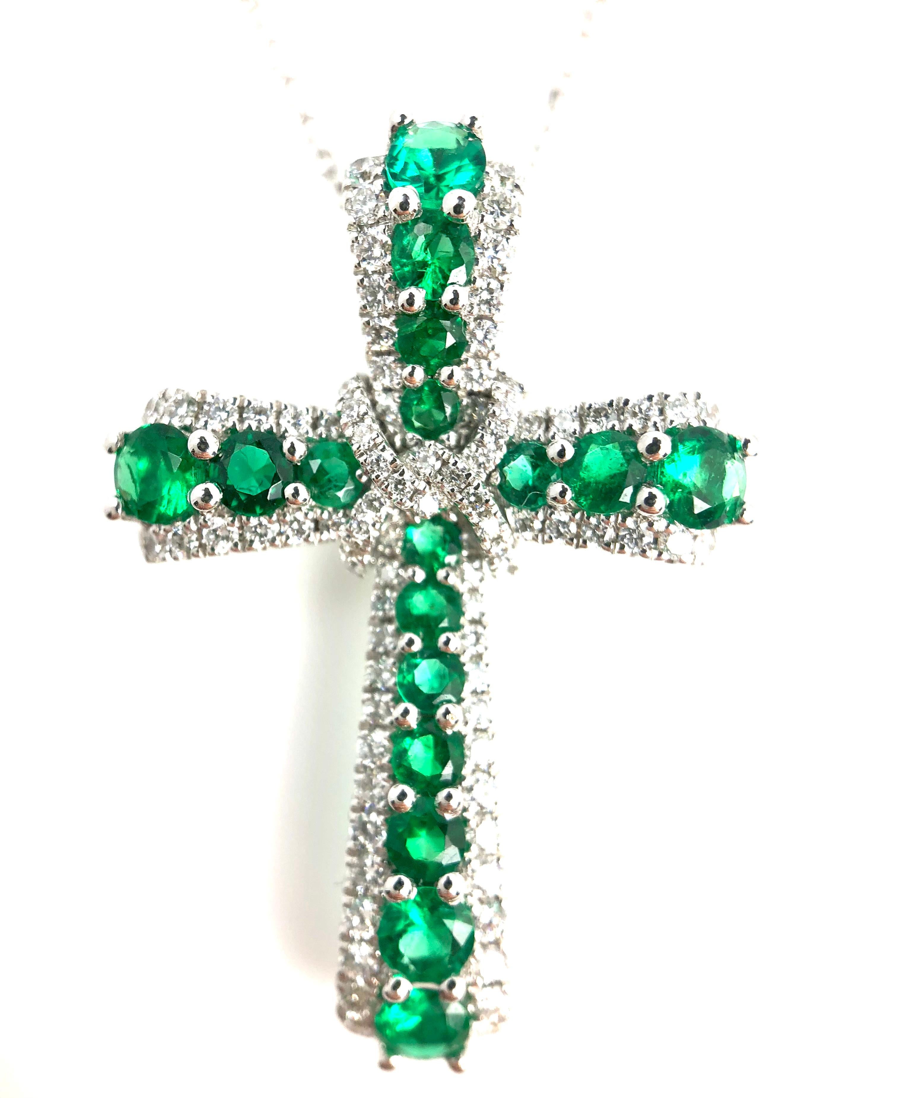 (DiamondTown) This pendant features 0.87 carats emeralds arranged in a cross and surrounded by a halo of white diamonds. An additional diamond embellishment surrounds the center of the cross. The total diamond weight is 0.39 carats.

Set in 18k