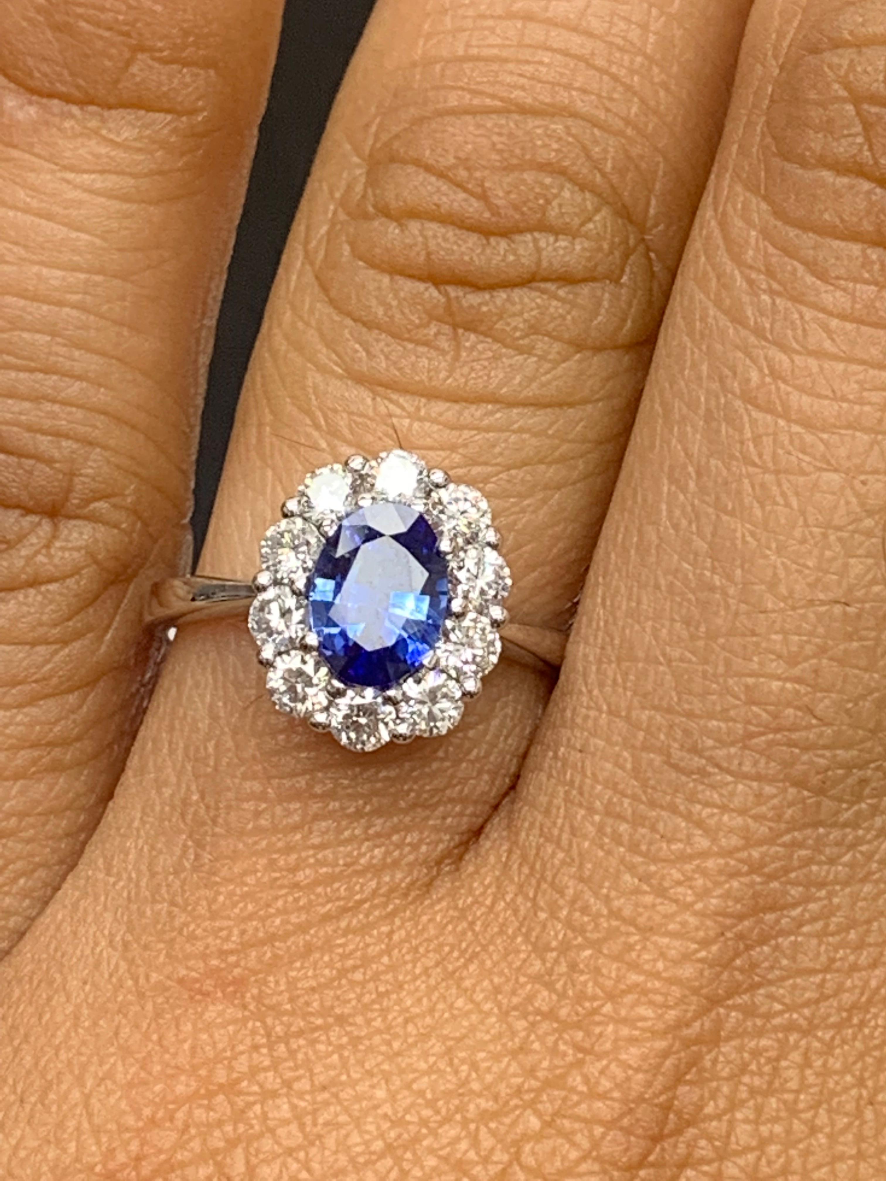 A simple floral motif ring showcasing a vibrant 0.87-carat oval cut blue sapphire, surrounded by 
0.74 carats of 10 accent round diamonds. Made in 18 karats white gold.

Style is available in different price ranges. Prices are based on your