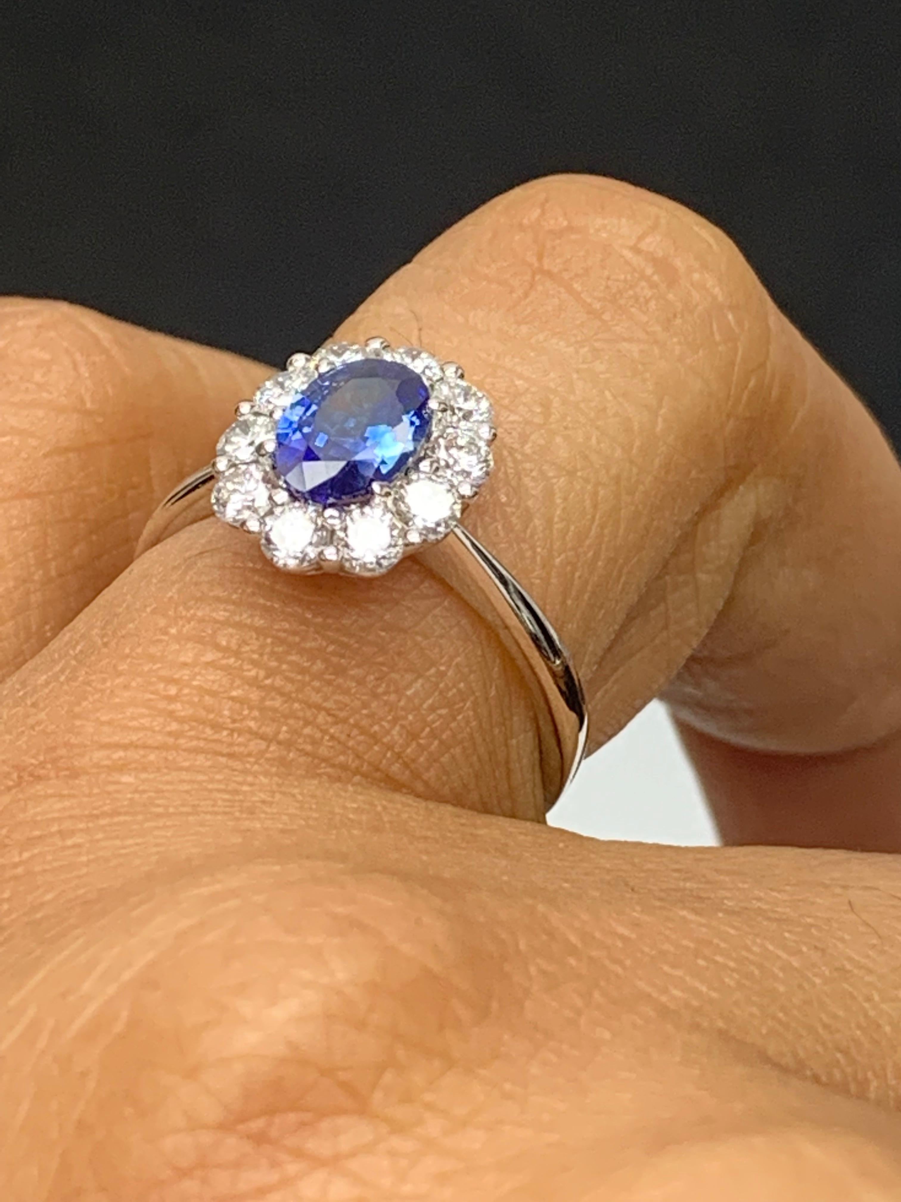 0.87 Carat Oval Cut Blue Sapphire and Diamond Halo Flower Ring in 18K White Gold In New Condition For Sale In NEW YORK, NY