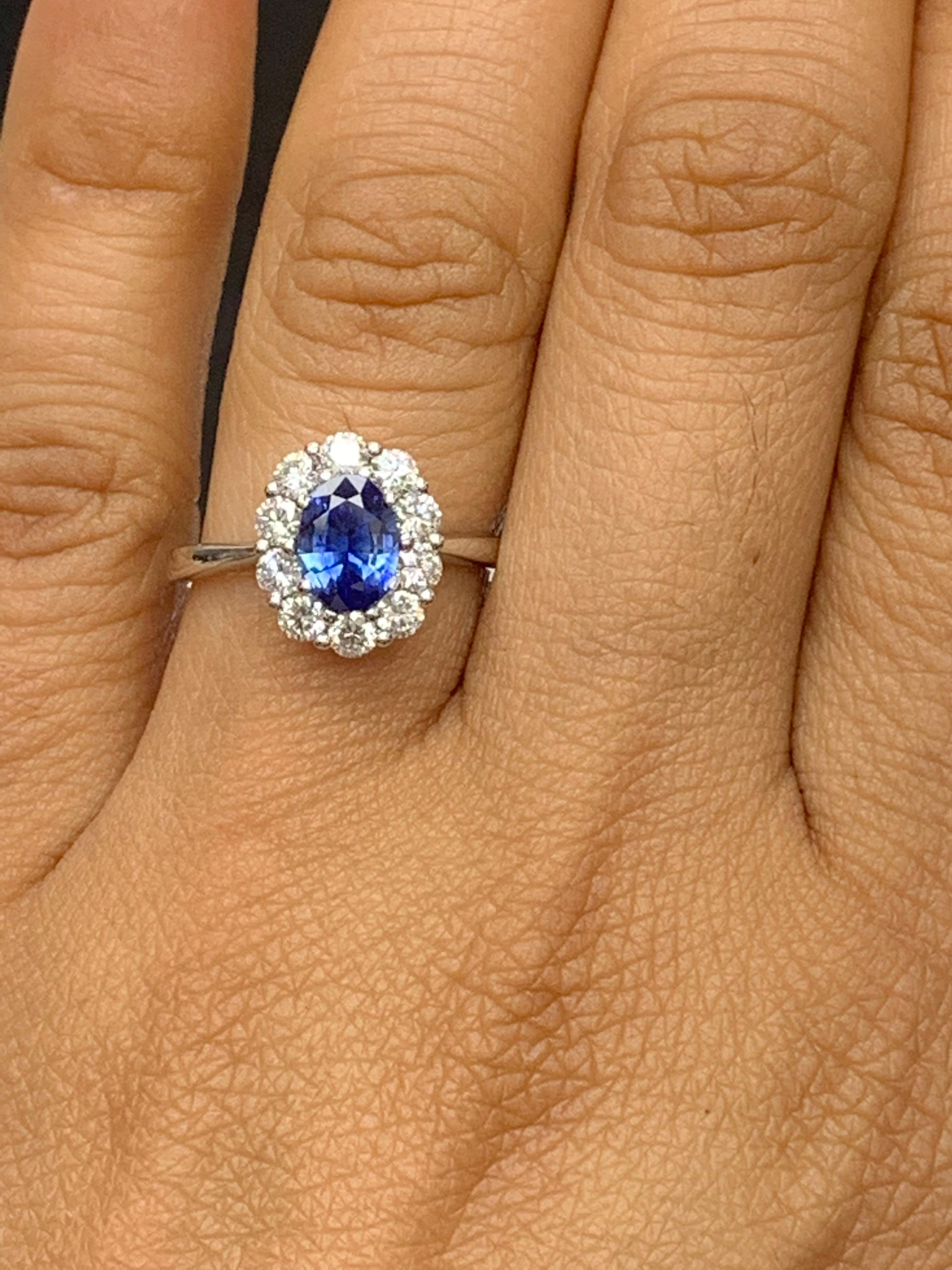 0.87 Carat Oval Cut Blue Sapphire and Diamond Halo Flower Ring in 18K White Gold For Sale 1