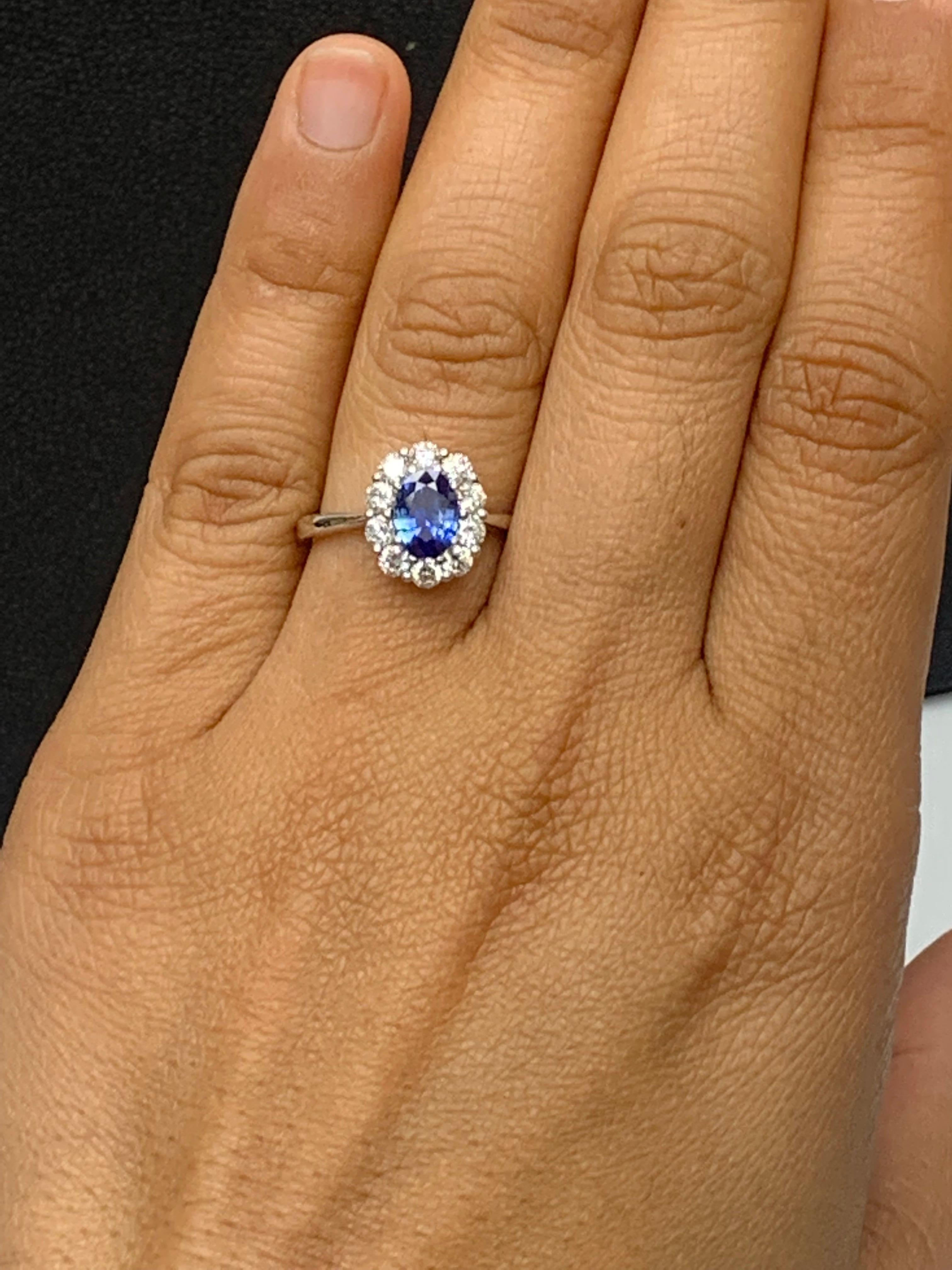 0.87 Carat Oval Cut Blue Sapphire and Diamond Halo Flower Ring in 18K White Gold For Sale 2