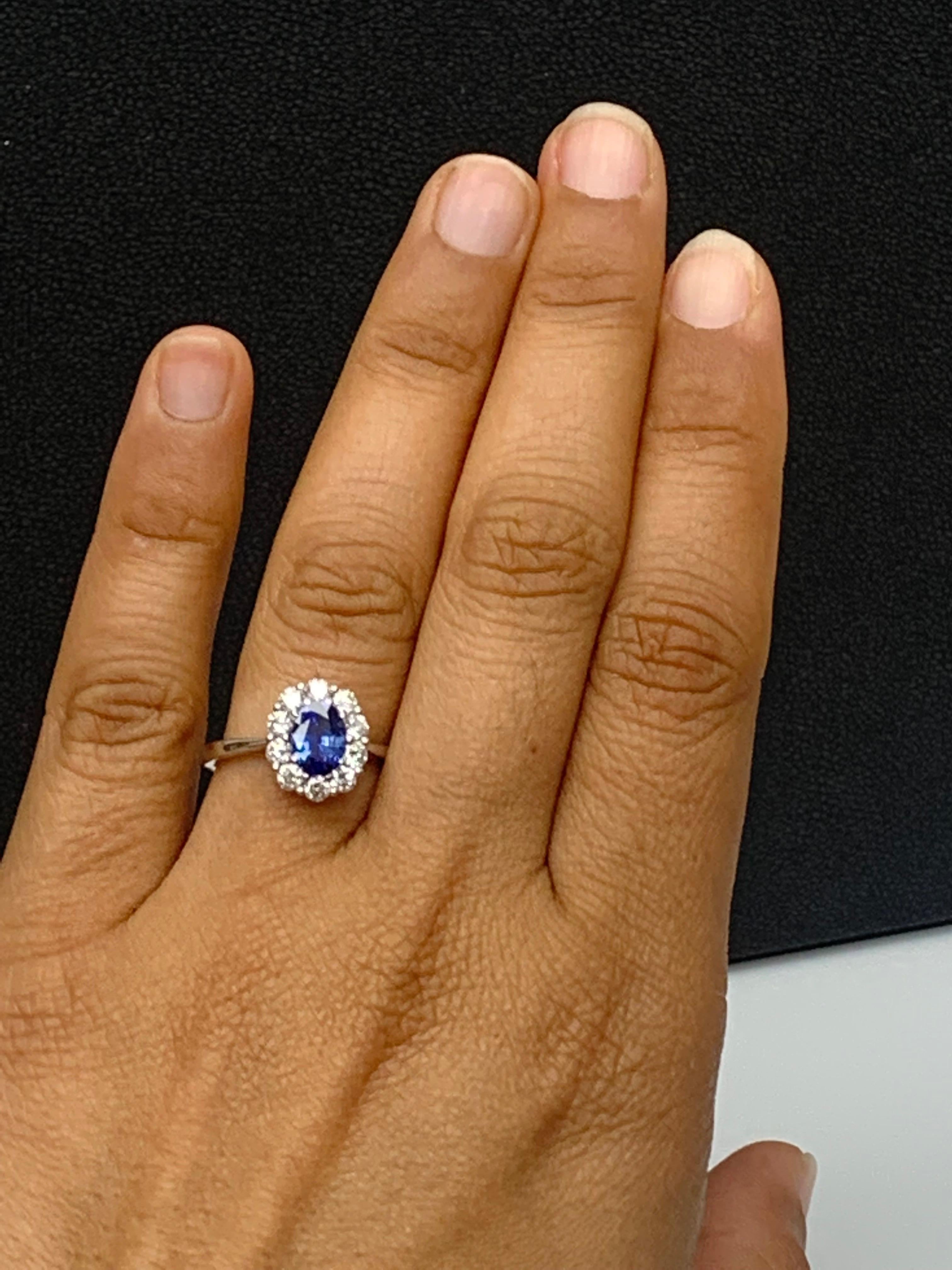 0.87 Carat Oval Cut Blue Sapphire and Diamond Halo Flower Ring in 18K White Gold For Sale 3