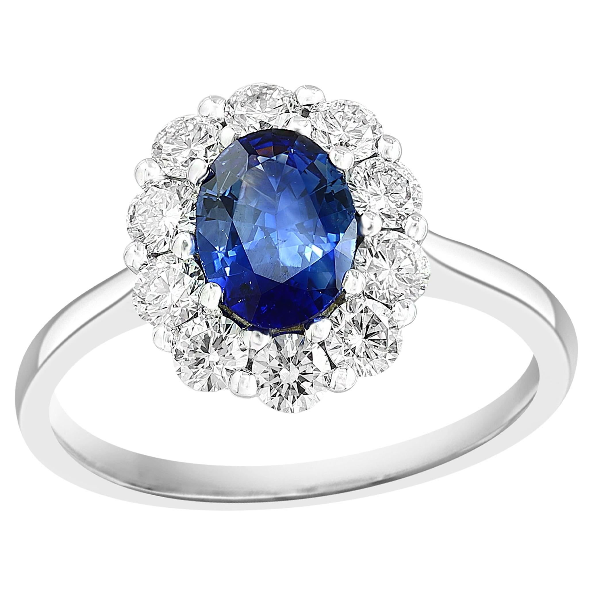 0.87 Carat Oval Cut Blue Sapphire and Diamond Halo Flower Ring in 18K White Gold For Sale