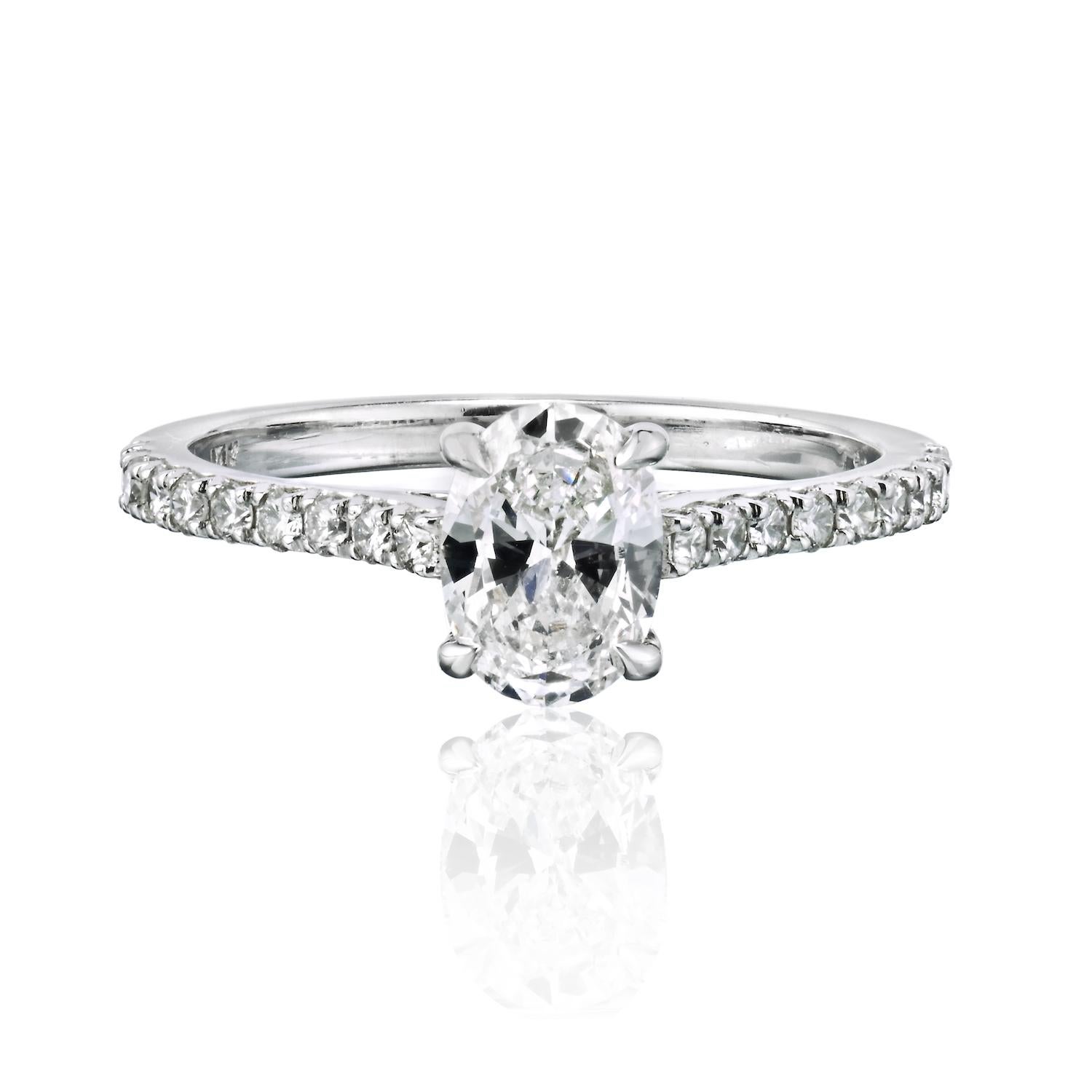 This lovely oval cut pave set diamond engagement ring features a 0.87-carat center diamond in a sparkly round brilliant diamond setting. 
Center diamond is GIA certified E color SI1 clarity, pave diamonds are of 0.27cts and are of similar quality.