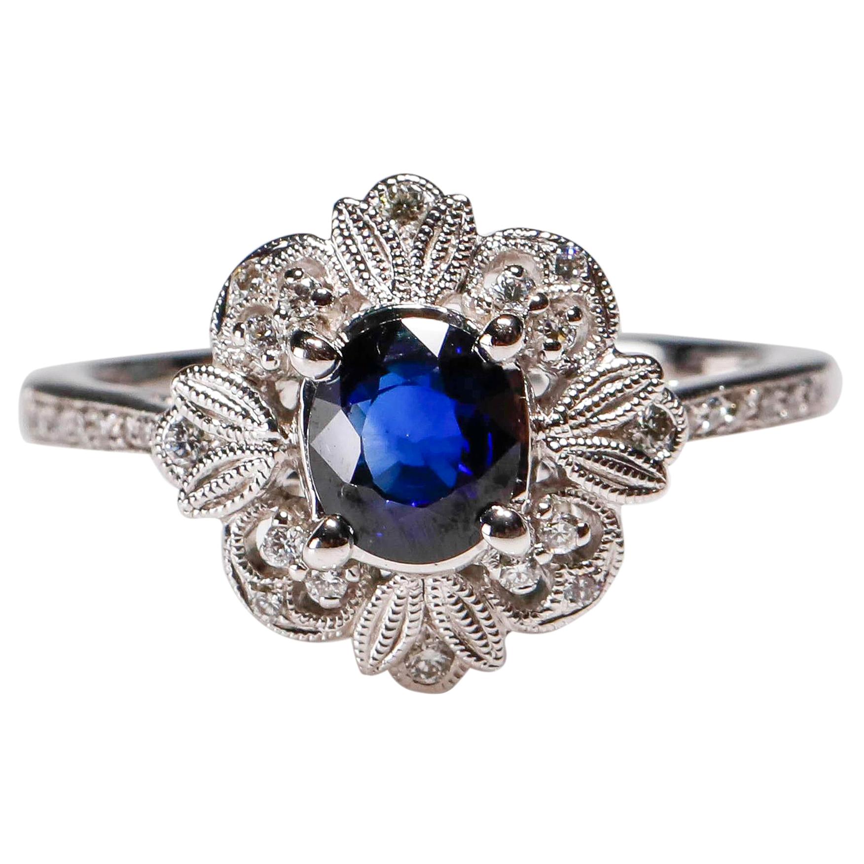 0.87 Carat blue Sapphire 0.13 Carat white Diamond 18 Karat Gold Floral Halo Ring
