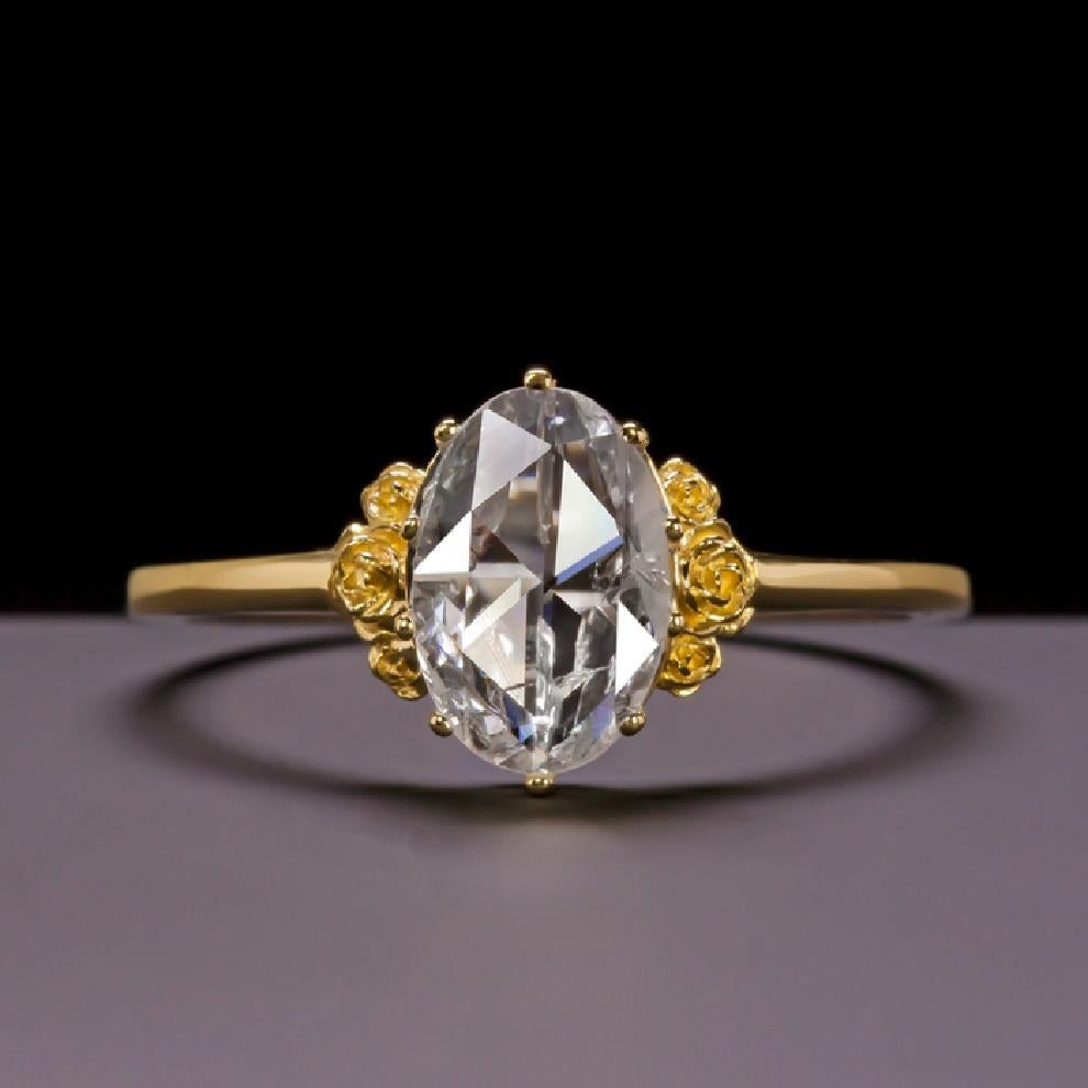 It is a ring that offers a splendid fusion of ancient and modern. 
It is a chic and romantic ring that features a 0.87 carat vintage diamond with a very old cut style, the rose cut in fact dates back to 1500. 
The setting is adorned with intricate
