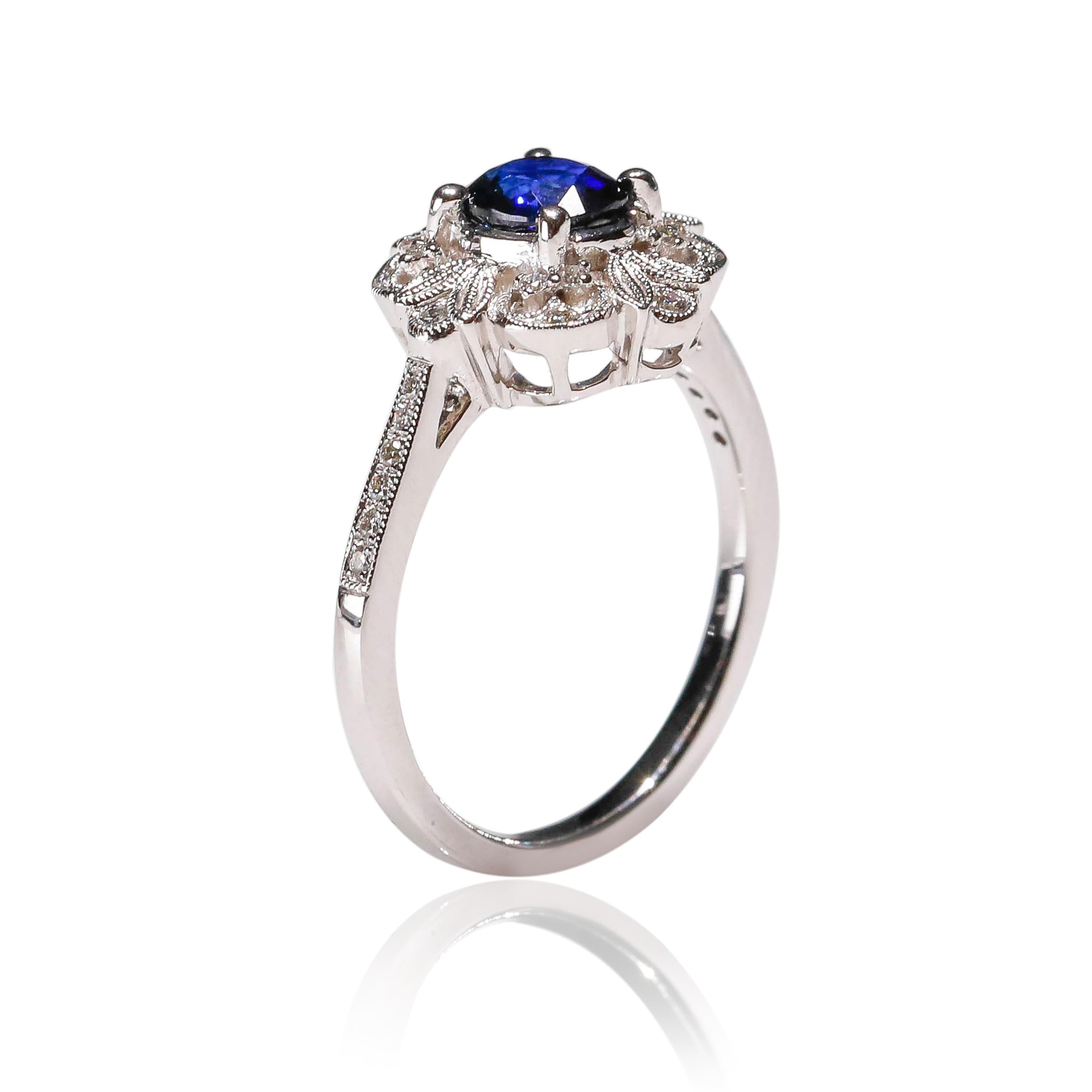 Art Deco 0.87 Carat blue Sapphire 0.13 Carat white Diamond 18 Karat Gold Floral Halo Ring