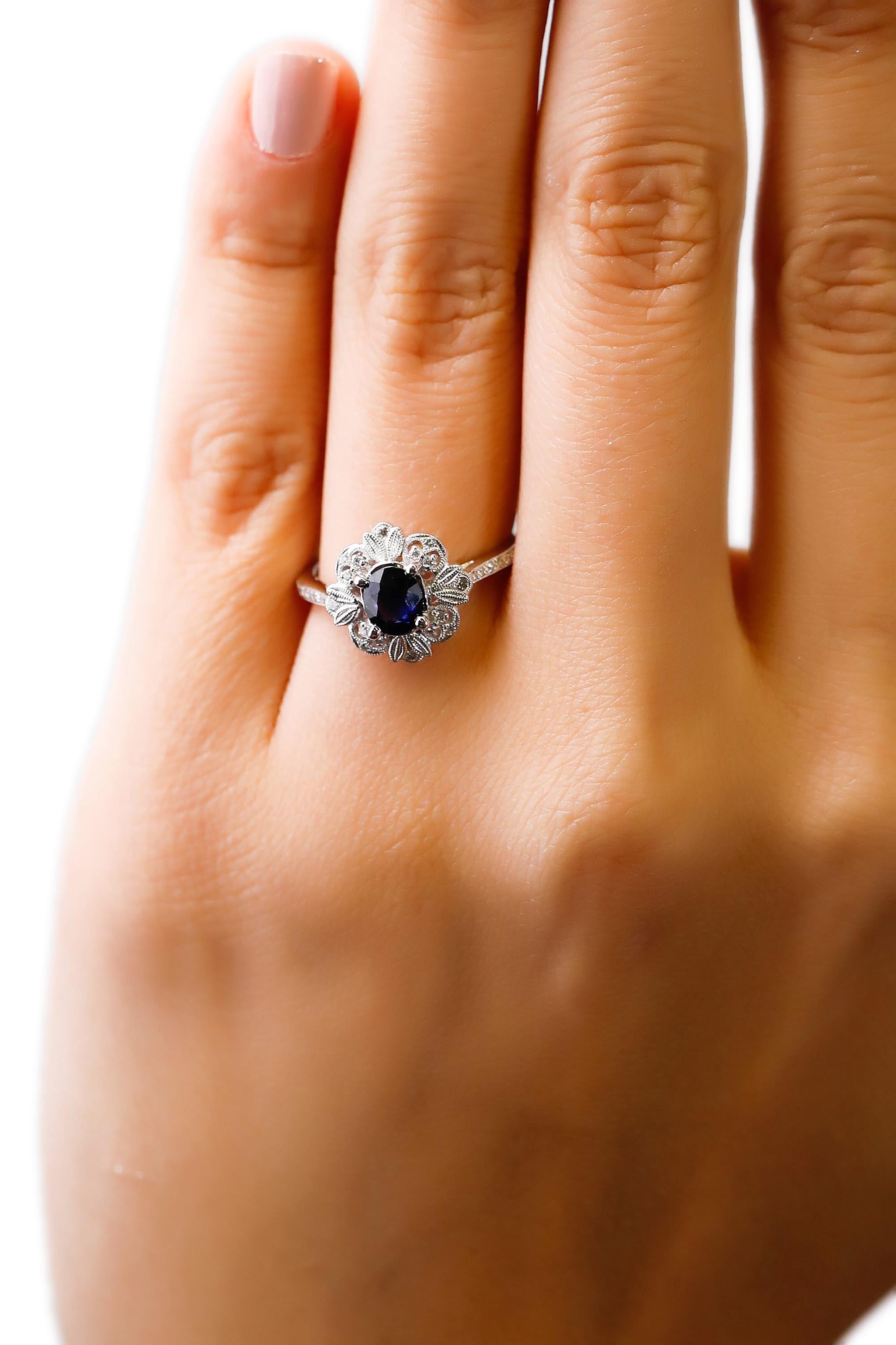 Oval Cut 0.87 Carat blue Sapphire 0.13 Carat white Diamond 18 Karat Gold Floral Halo Ring