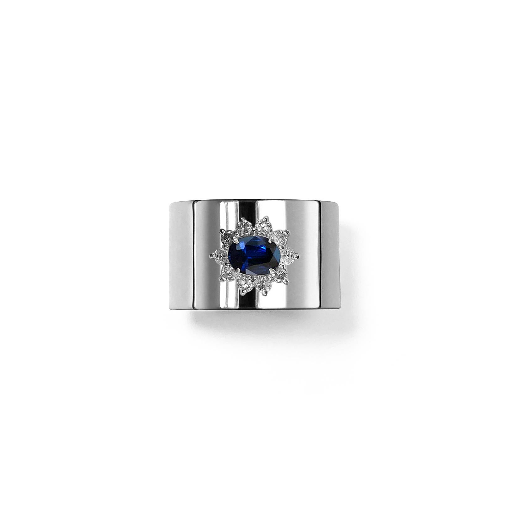 This luxurious wide-band platinum ring features deconstructed elements from repurposed vintage Sapphire stone settings in the center. These rare and classic settings were made by highly skilled craftsmen and includes brilliant cut diamonds. This is