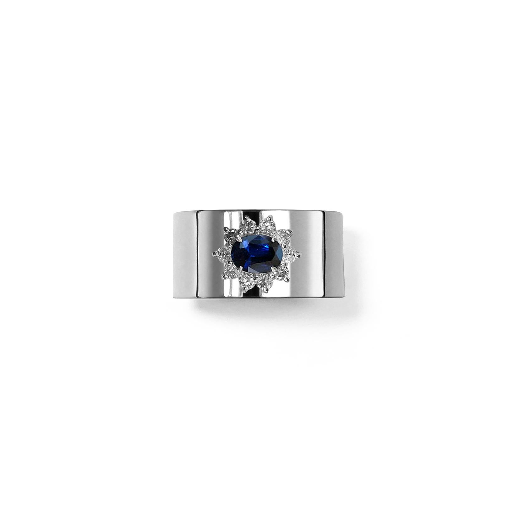 This luxurious wide-band platinum ring features deconstructed elements from repurposed vintage Sapphire stone settings in the center. These rare and classic settings were made by highly skilled craftsmen and includes brilliant cut diamonds. This is