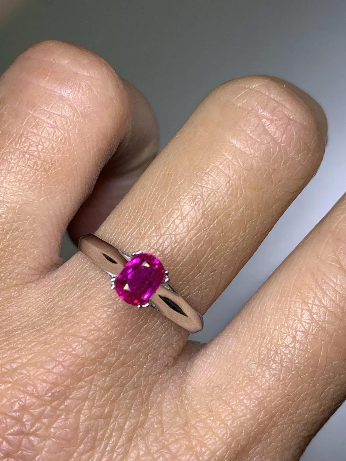 This stunning 0.87ct Ruby Burma Oval Shaped Solitaire Engagement Ring is a true showstopper. Crafted from 18ct White Gold, this ring is the epitome of luxury and elegance. The oval-shaped ruby stone is the star of the show, with its vibrant red