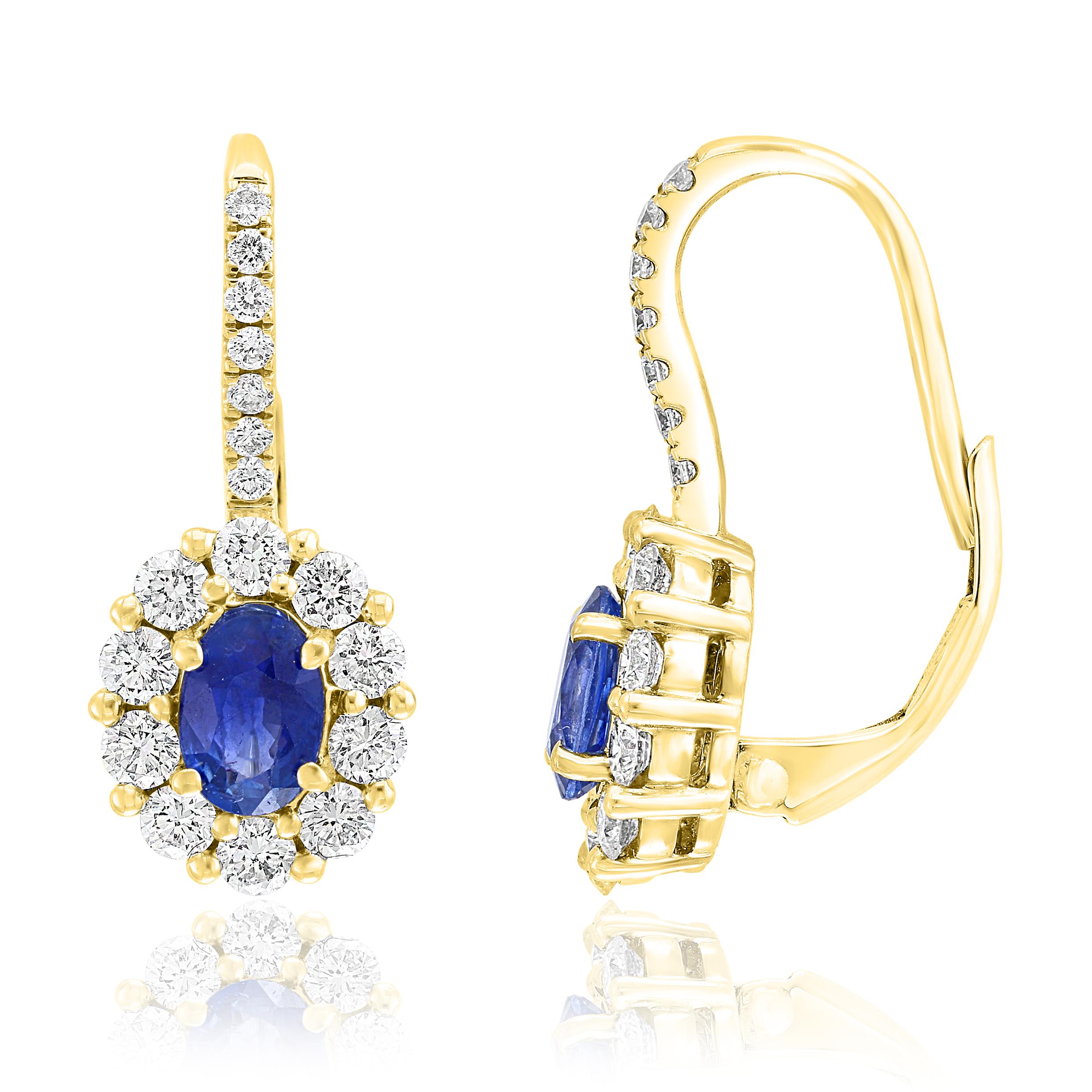 A simple pair of Lever back earrings showcasing 0.88 carats of oval cut blue sapphires, surrounded by a single row of 34 round brilliant diamonds weighing 0.92 carats. Made in 18-karat Yellow gold.