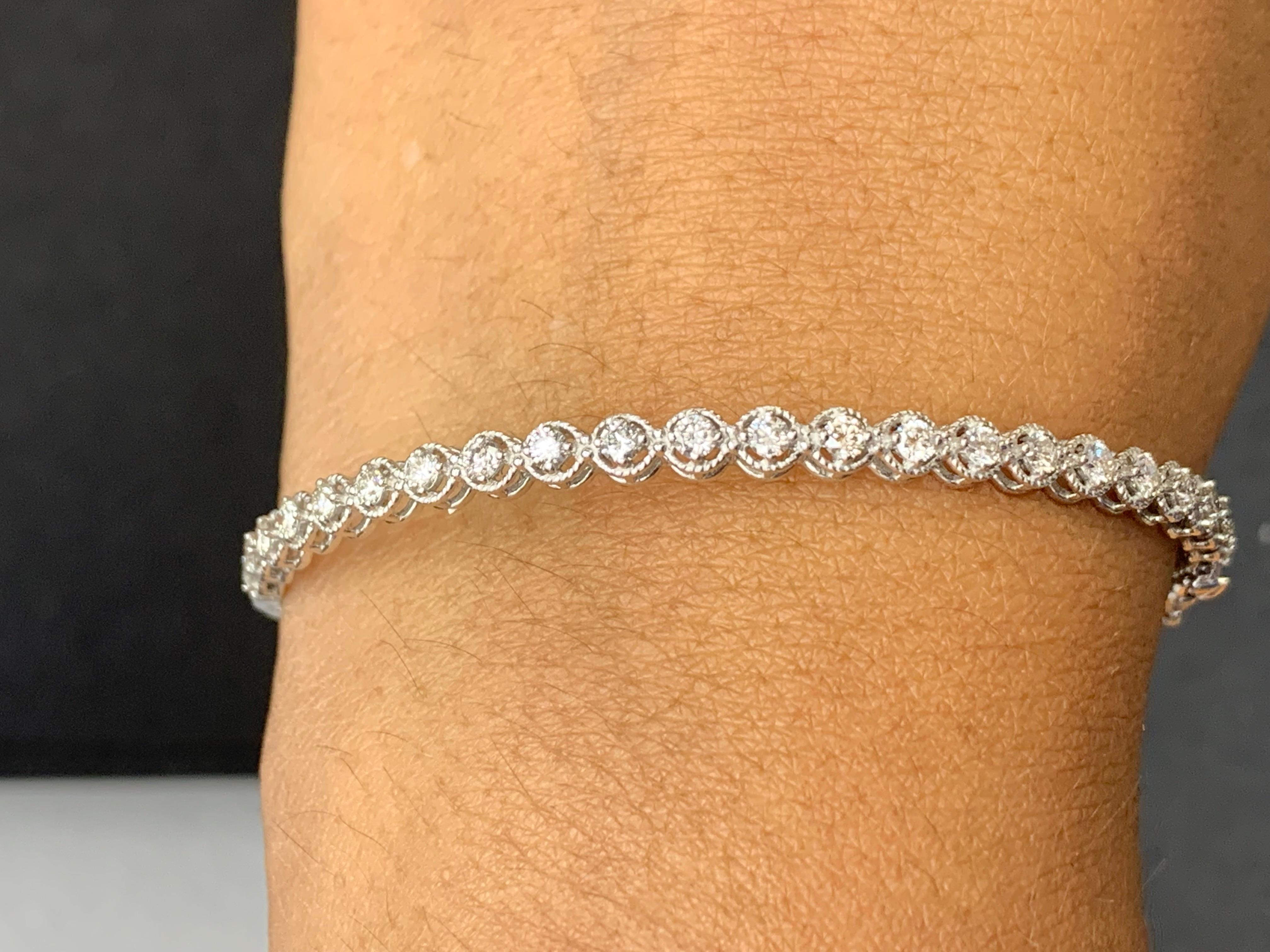A stunning bangle bracelet set with 23 sparkling round diamonds weighing 0.88 carats total. Diamonds are set in round rope design polished 14k white gold. Double lock mechanism for maximum security. A simple yet dazzling piece.